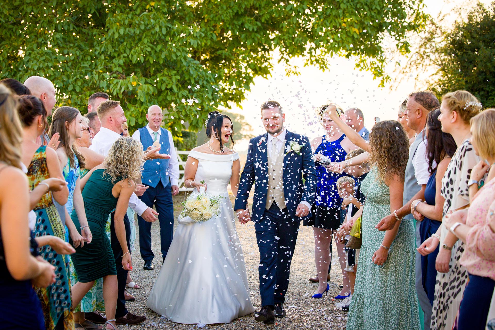 Bride and groom with confetti by Essex wedding photographer at The Compasses at Pattiswick