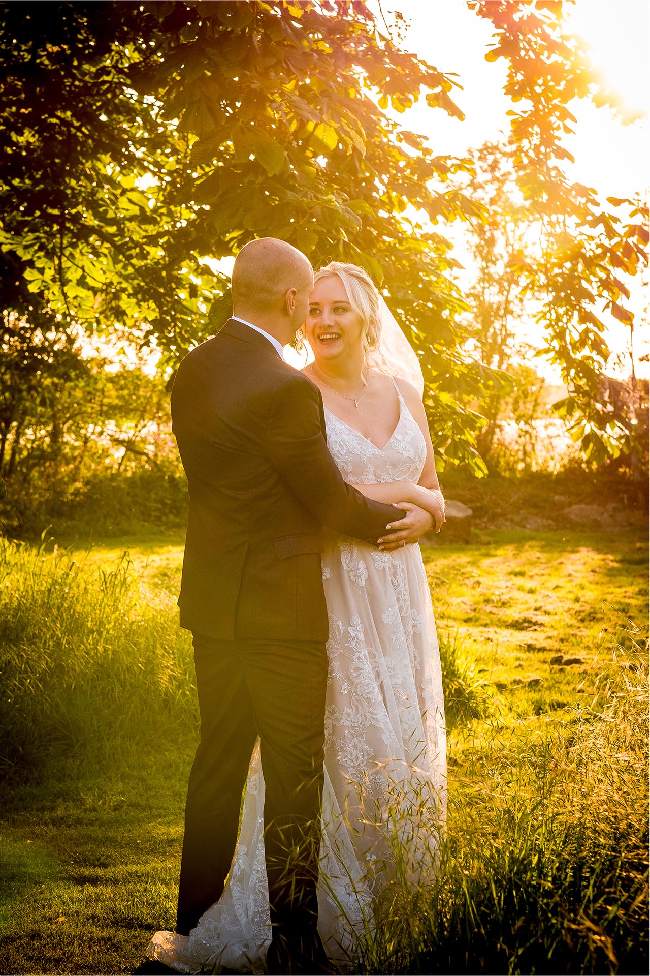 Bride and groom golden light photograph by Essex wedding photographer at Vaulty Manor Maldon