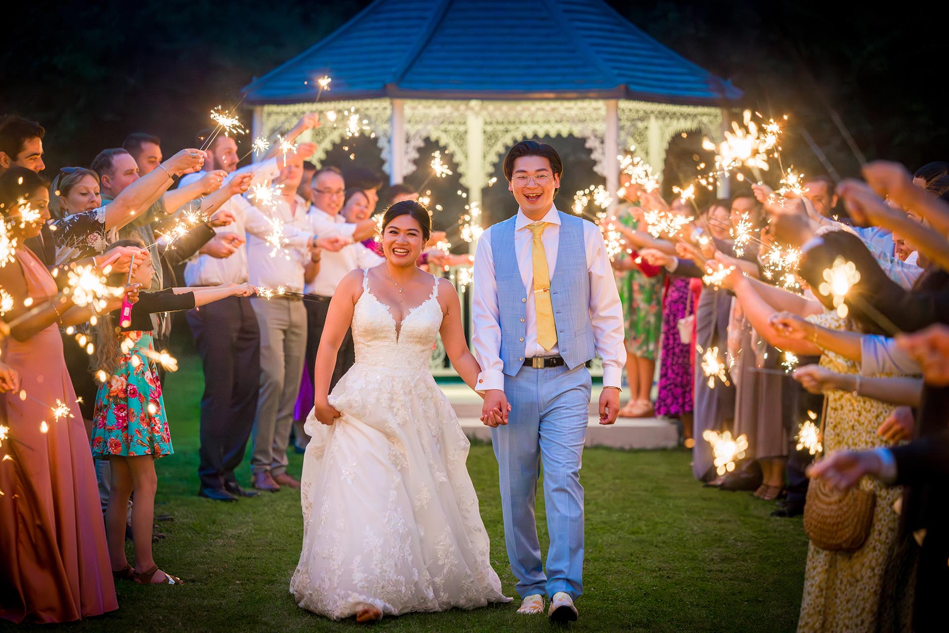 Bride and groom with sparklers by Essex reportage wedding photographer at The Grand Marquee Brentwood
