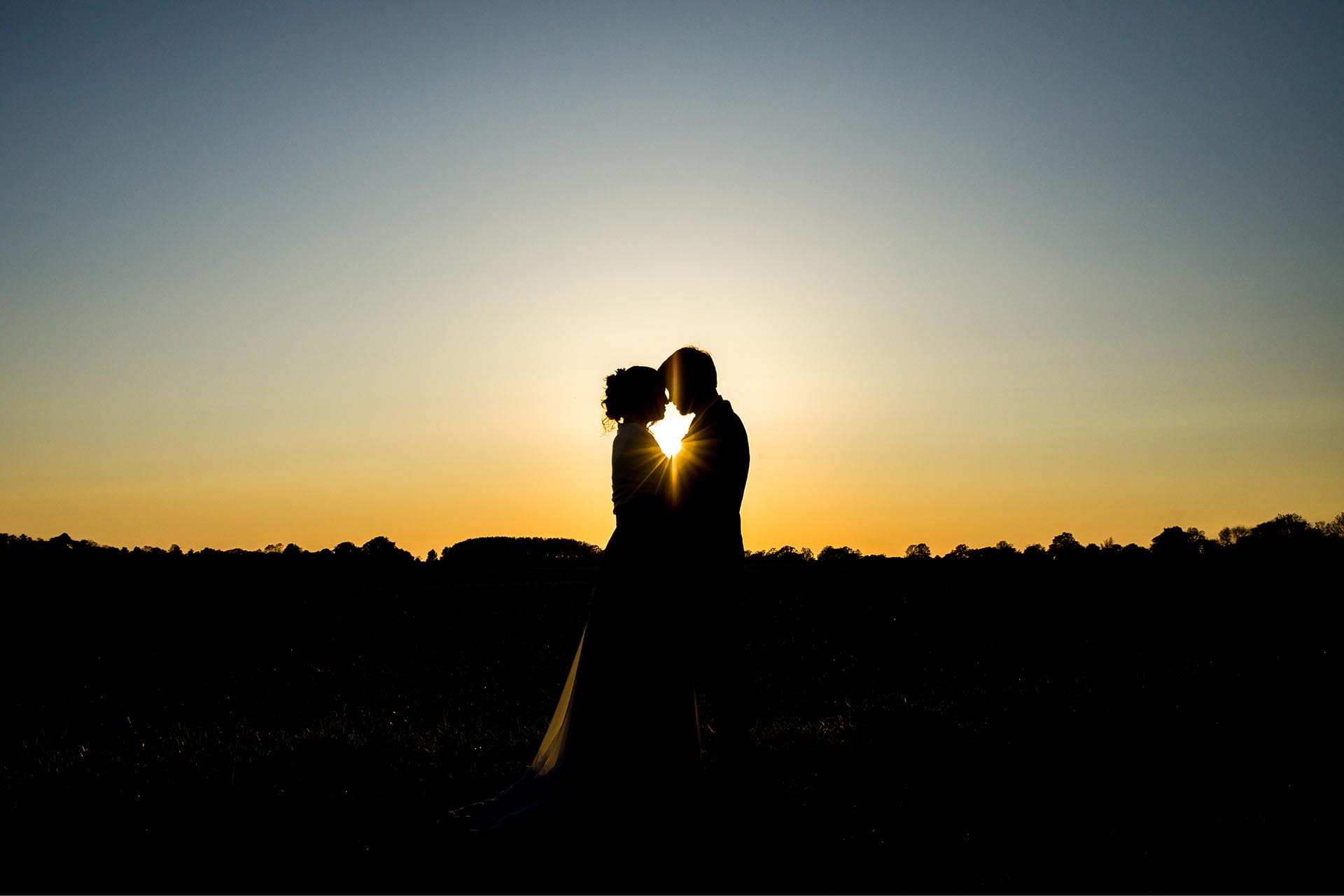 Bride and groom at sunset by Essex wedding photographer at Great Lodge, Great Bardfield