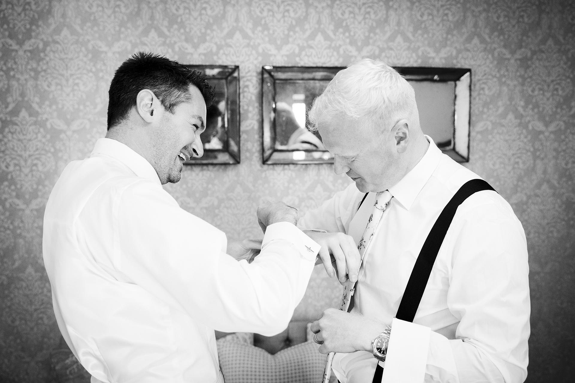 Black and white reportage wedding photography during groom's preparations at Leez Priory, Great Leighs, Chelmsford, Essex