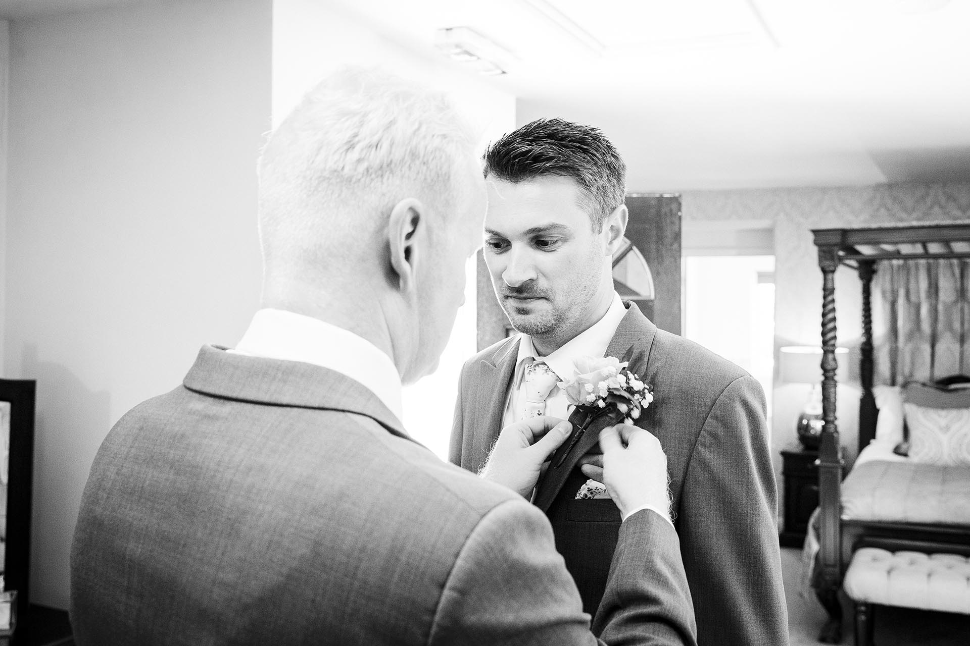 Black and white reportage wedding photography of groom's preparations before the wedding ceremony at Leez Priory, Great Leighs, Chelmsford by Essex wedding photographer