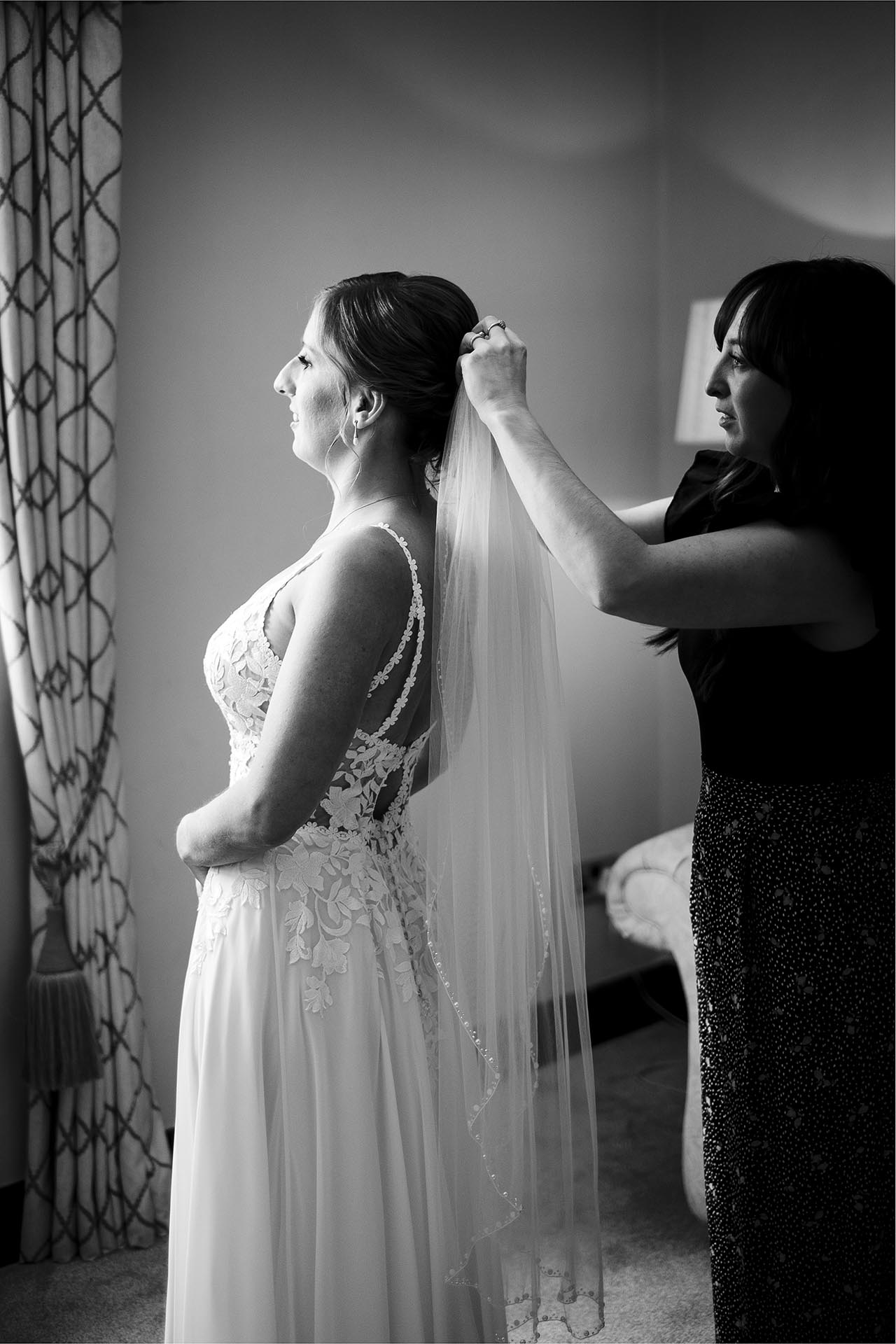Black and white reportage wedding photography of bridal preparations before the wedding ceremony at Leez Priory, Great Leighs, Chelmsford by Essex wedding photographer