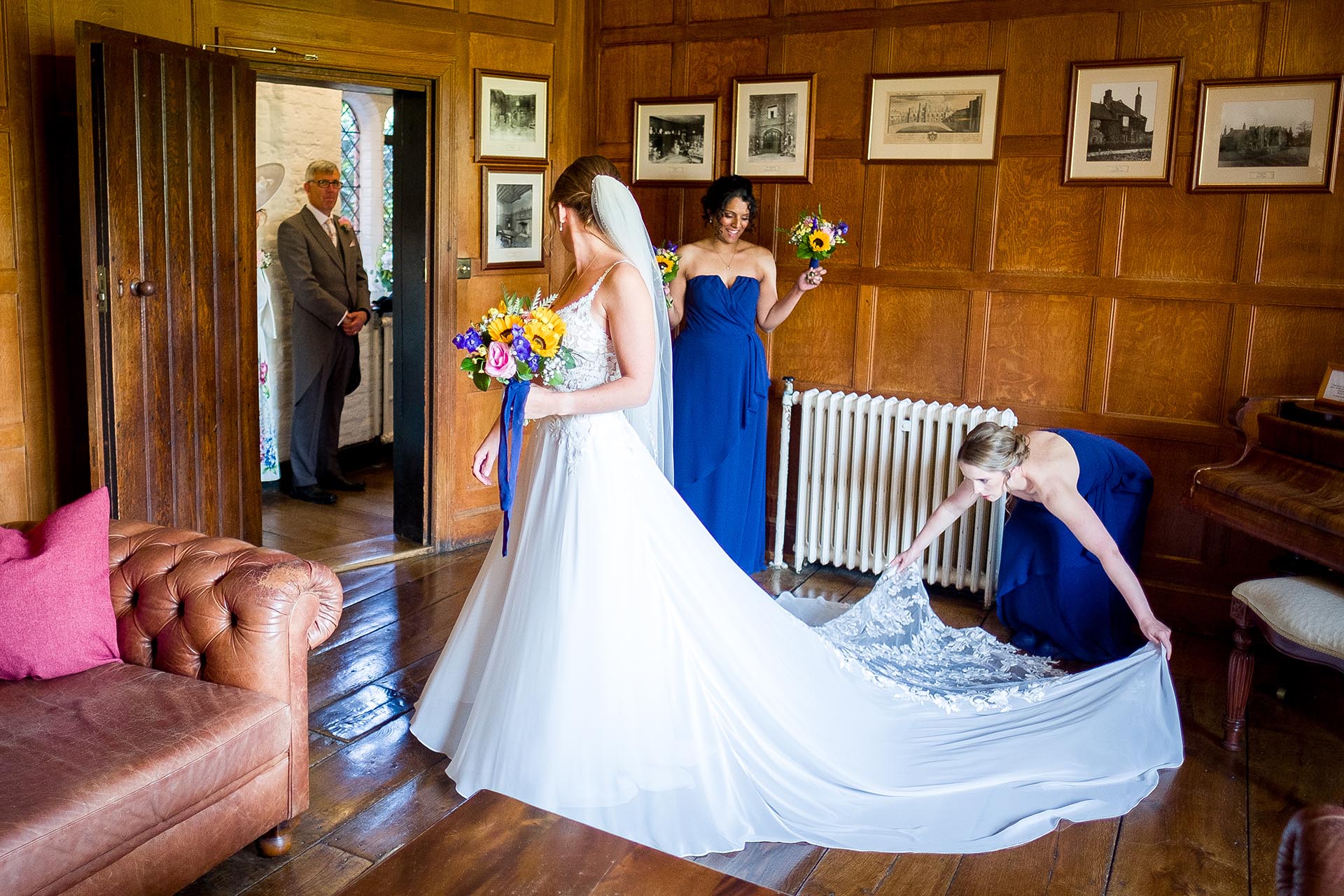 Bride and bridesmaids making final preparations before the wedding ceremony at Leez Priory, Great Leighs, Chelmsford by Essex wedding photographer