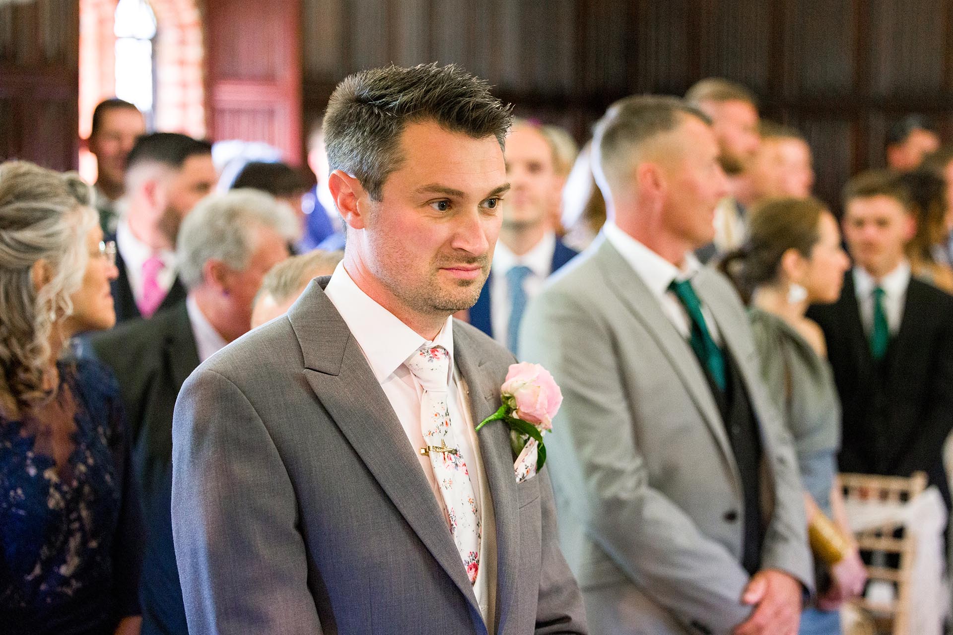 Groom waiting for start of wedding ceremony at Leez Priory, Great Leighs, Chelmsford by Essex wedding photographer