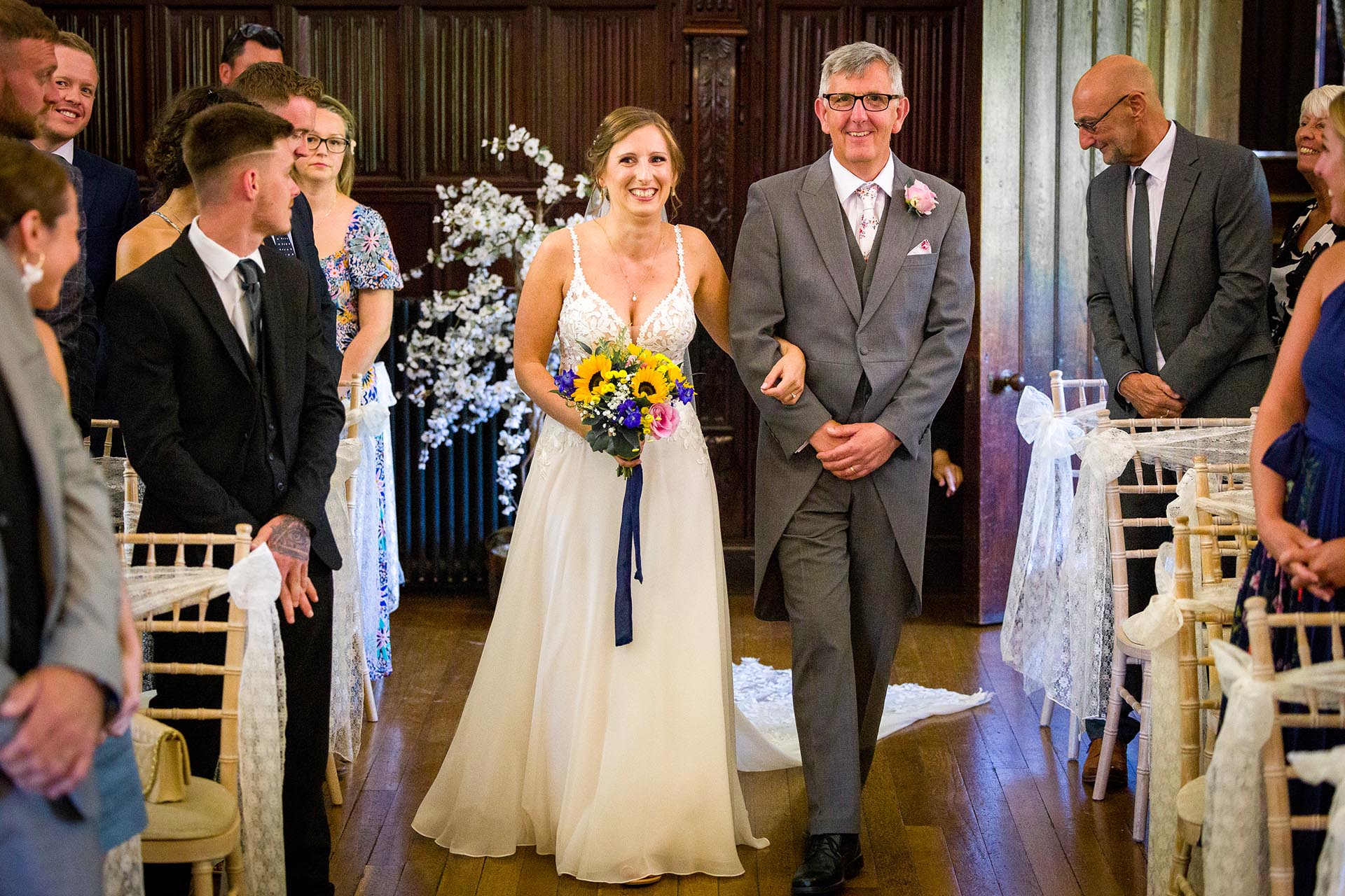 Bride entering the wedding ceremony with her father at Leez Priory, Great Leighs, Chelmsford by Essex wedding photographer