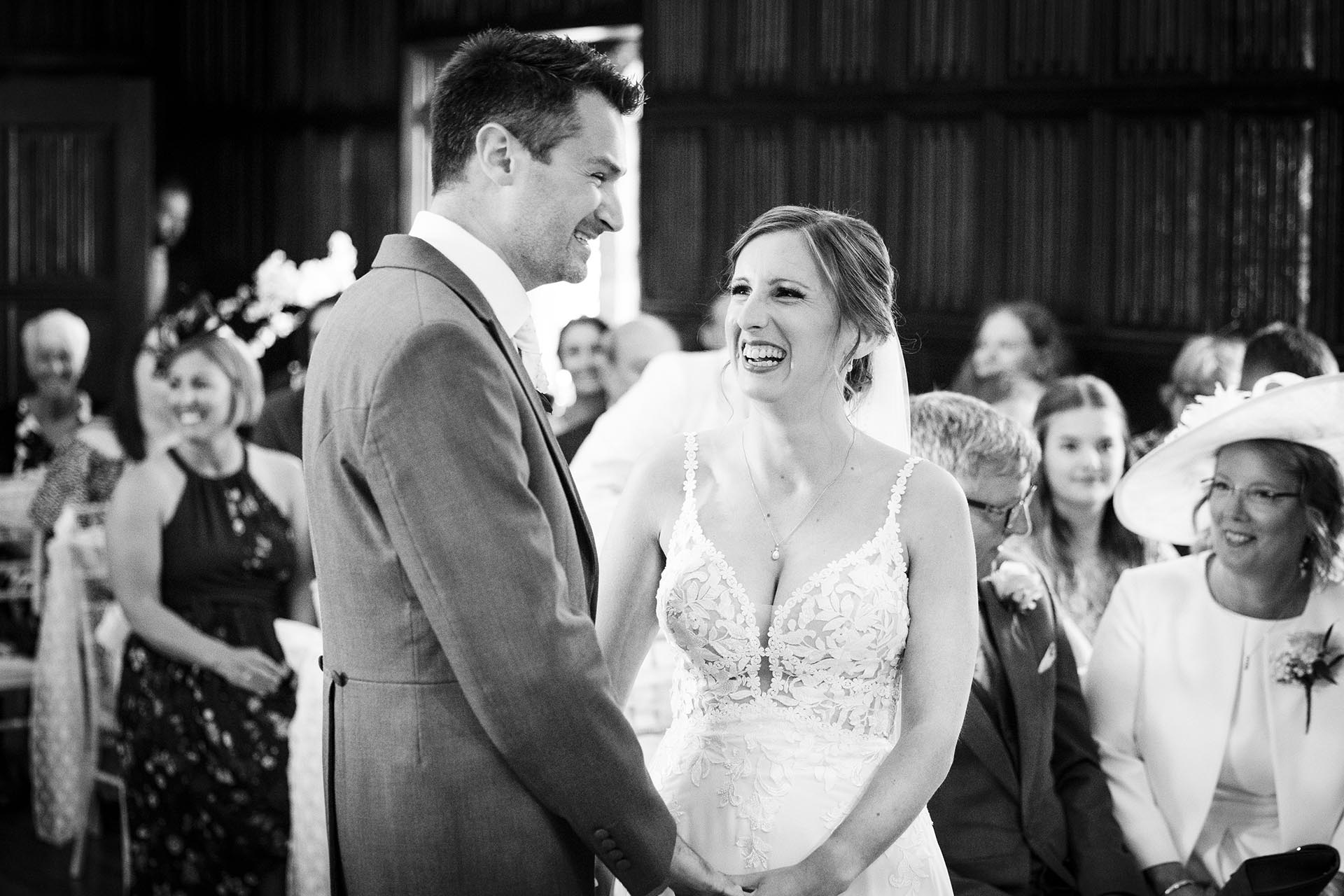 Black and white photograph of bride and groom during their wedding ceremony at Leez Priory, Great Leighs, Chelmsford by Essex wedding photographer