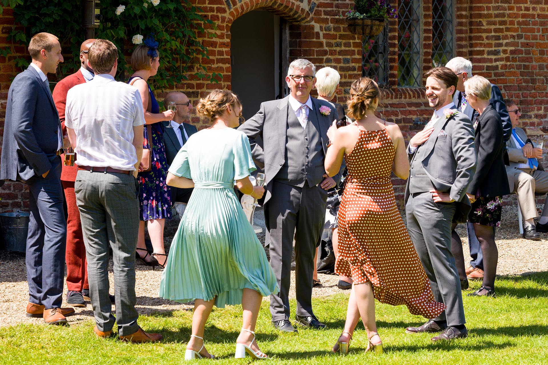 Wedding guests enjoying the summer sunshine at Leez Priory, Great Leighs, Chelmsford