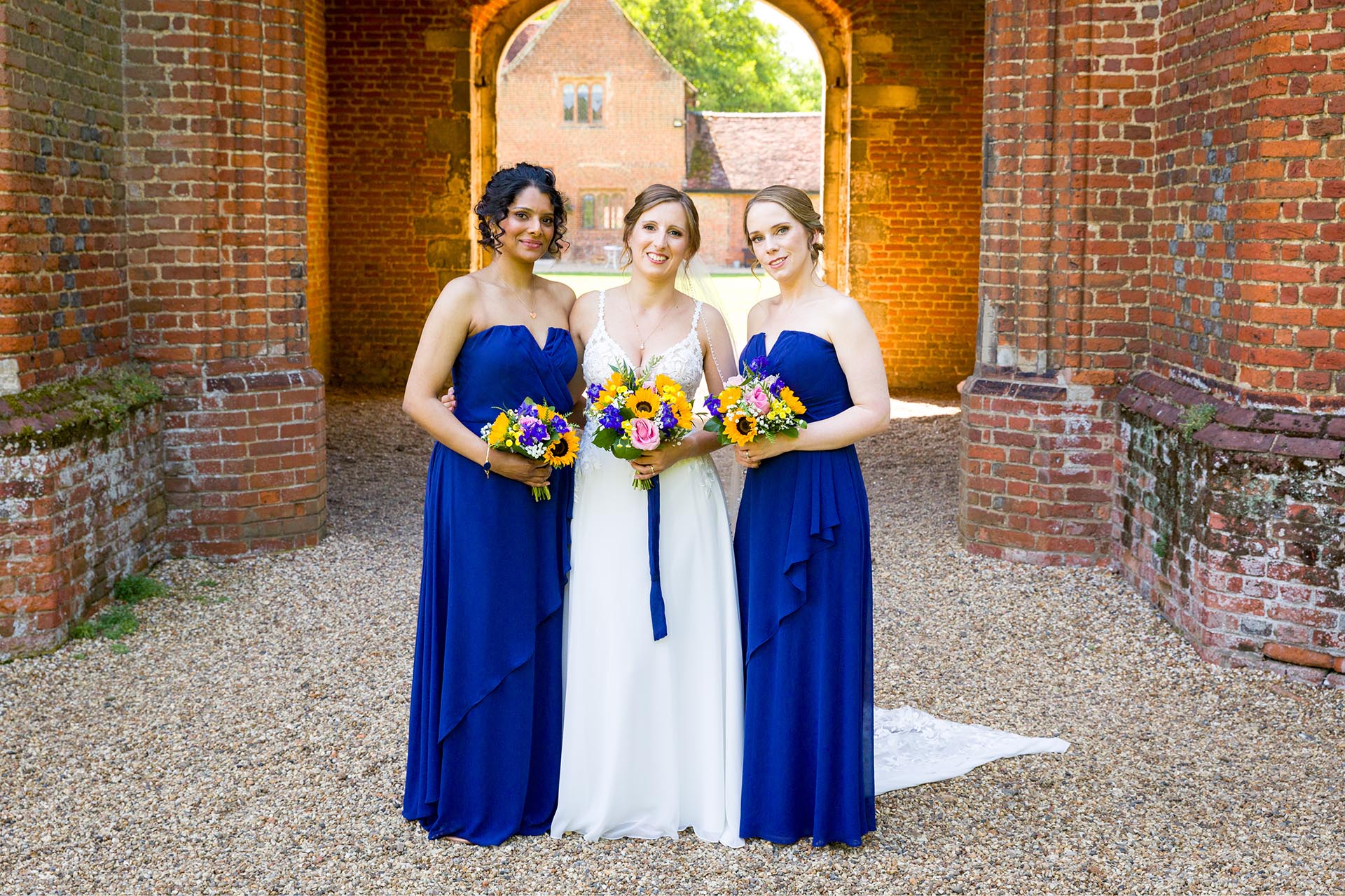 Bride and bridesmaids at a summer Leez Priory wedding, Great Leighs, Chelmsford, by Essex wedding photographer