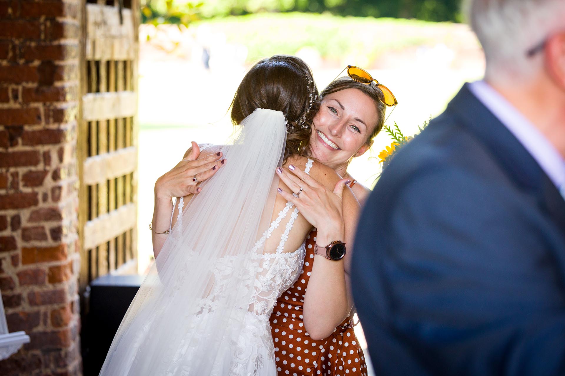 Wedding guest hugging the bride at Leez Priory, Great Leighs, Chelmsford, by Essex wedding photographer