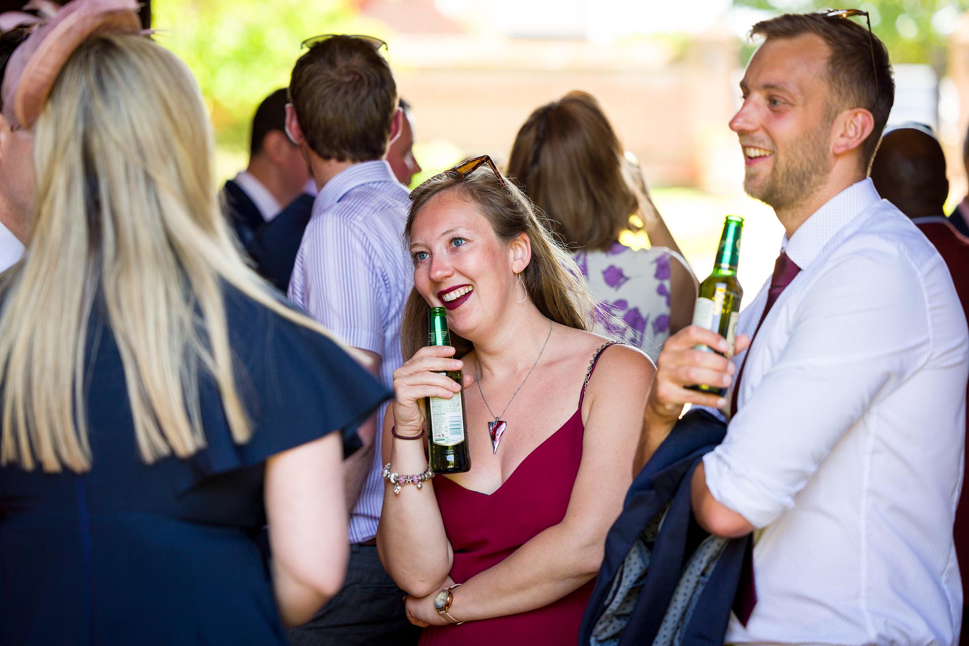 Wedding guests enjoying a drink at a Leez Priory wedding, Great Leighs, Chelmsford, by Essex wedding photographer