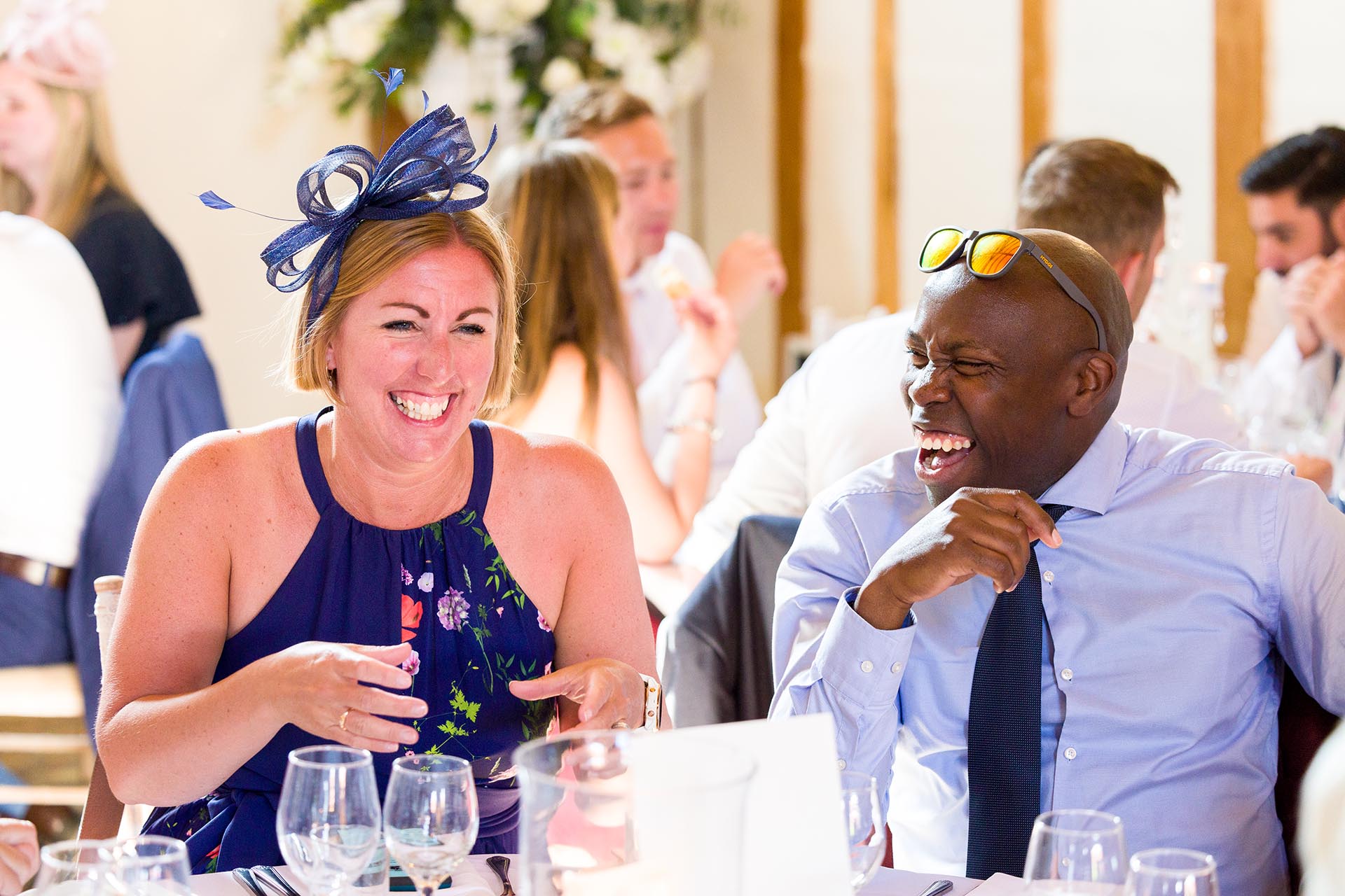 Guests laughing during wedding breakfast at Leez Priory, Great Leighs, Chelmsford, by Essex wedding photographer