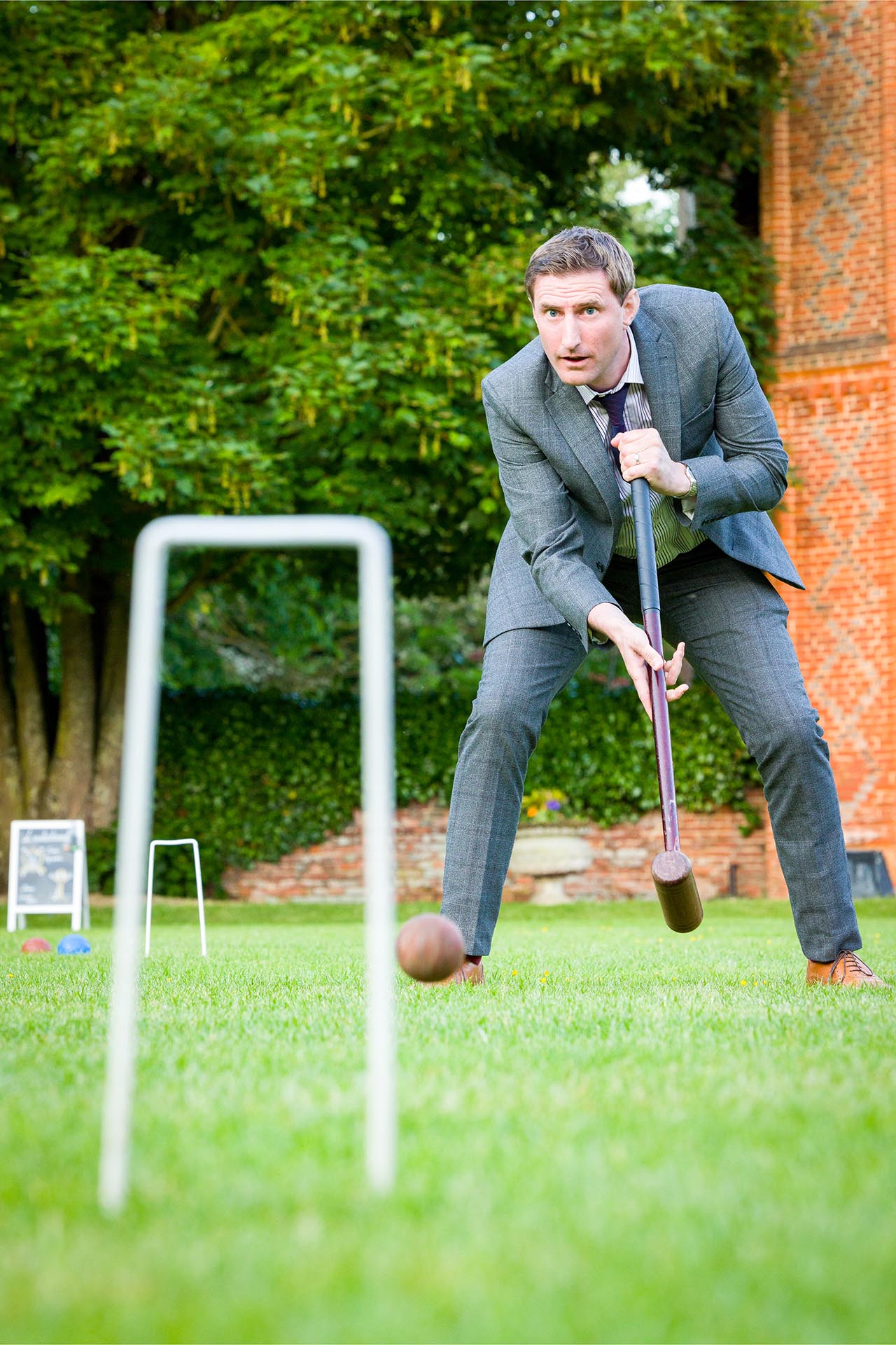 Wedding guest playing croquet at a Leez Priory wedding, Great Leighs, Chelmsford, Essex