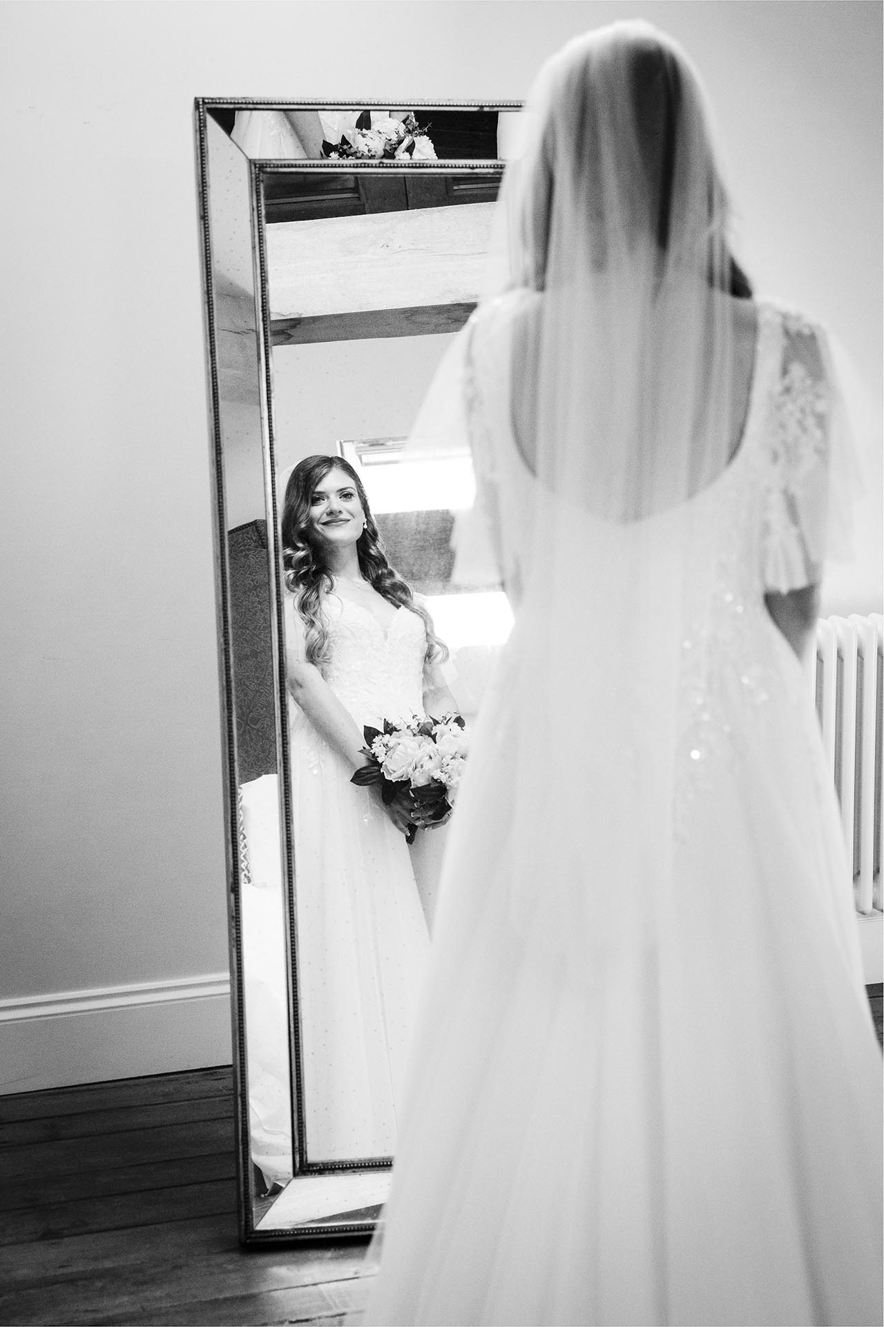 Photograph of the bride in a mirror at Apton Hall, Rochford, Essex