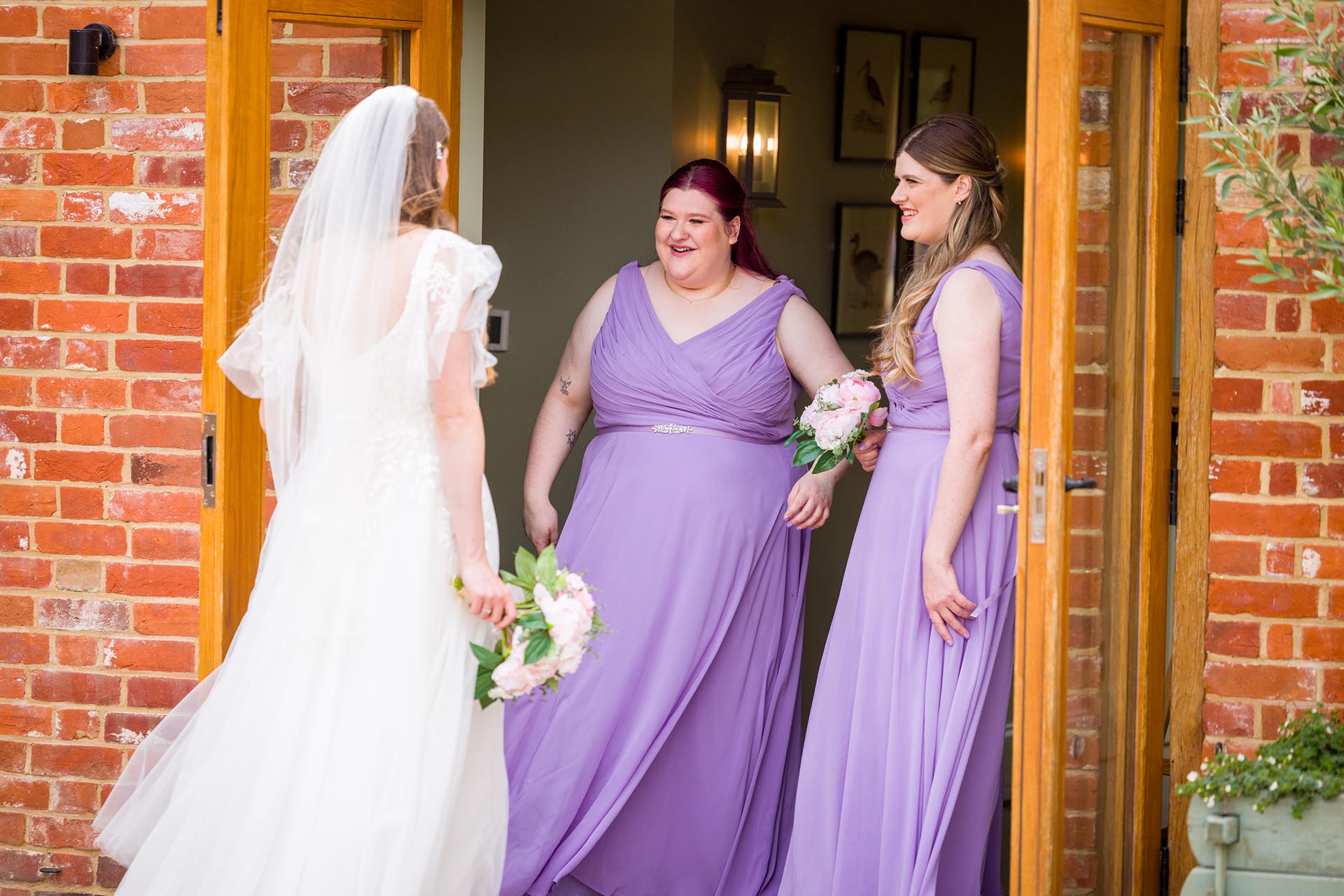 Photograph of bridesmaids looking at the bride at Apton Hall, Rochford, Essex