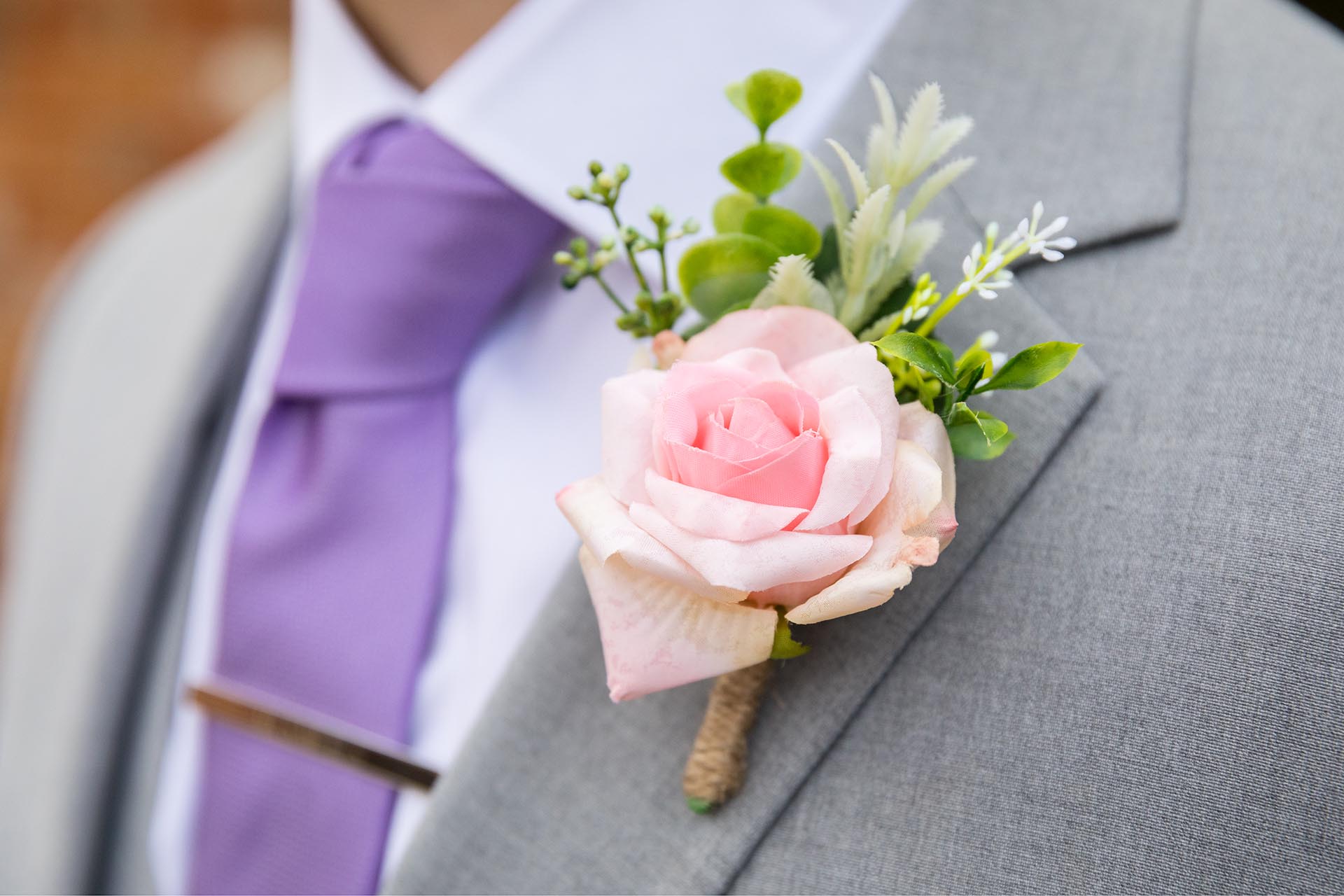 Close up photograph of the groom's buttonhole flower at Apton Hall, Rochford, Essex