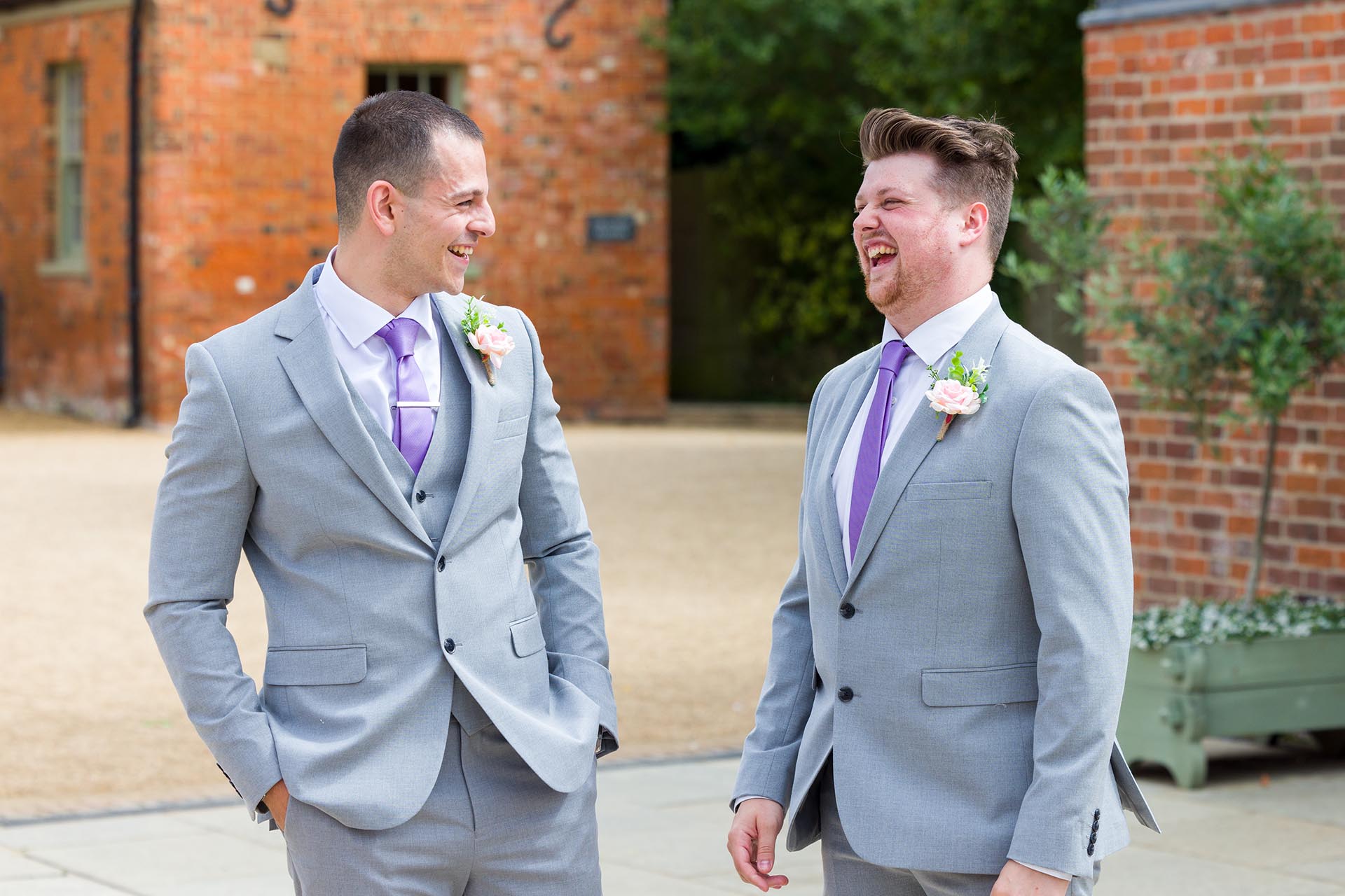 Photograph of the groom and a groomsman laughing at Apton Hall, Rochford, Essex