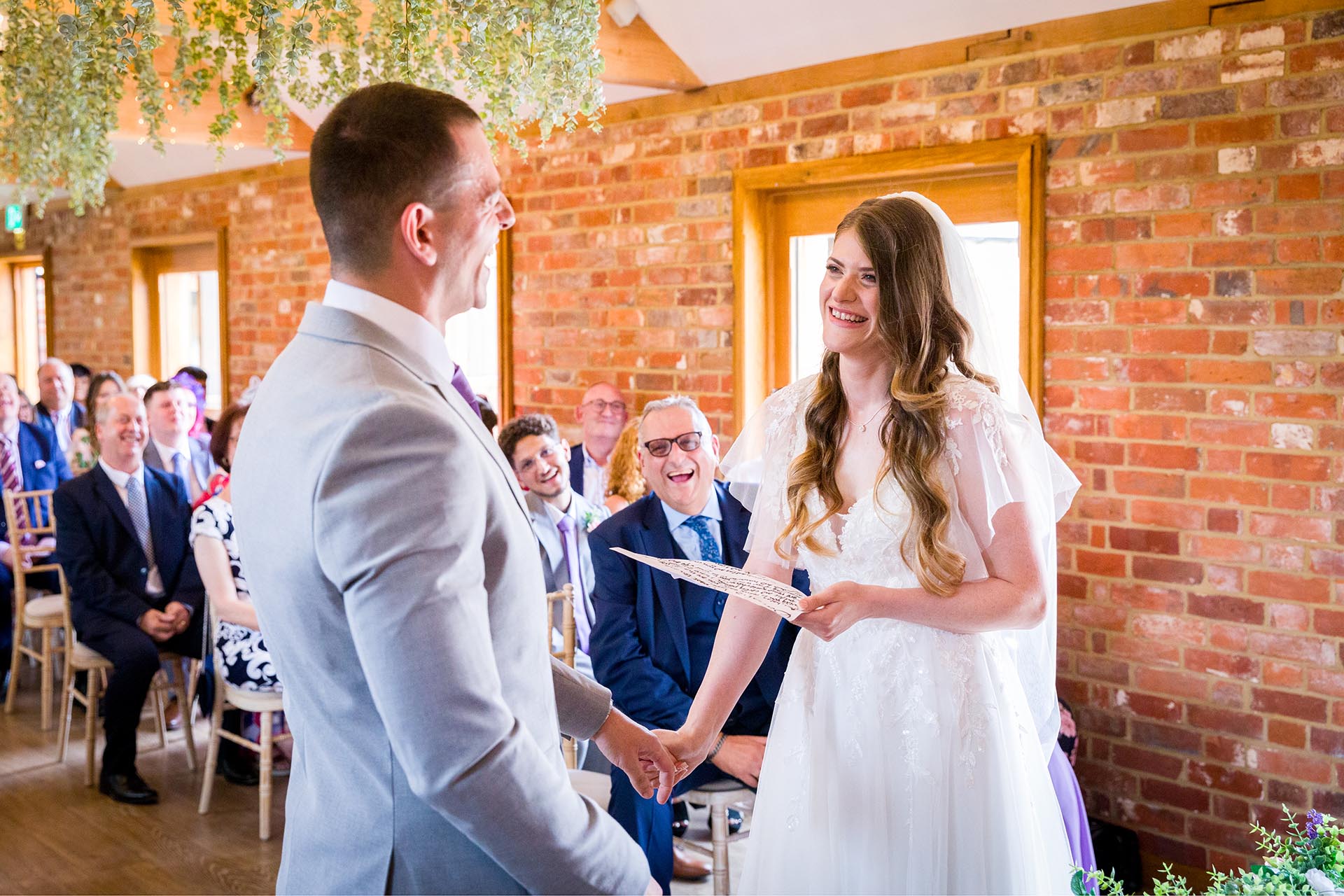 Photograph of bride and groom during the wedding ceremony at Apton Hall, Rochford, Essex