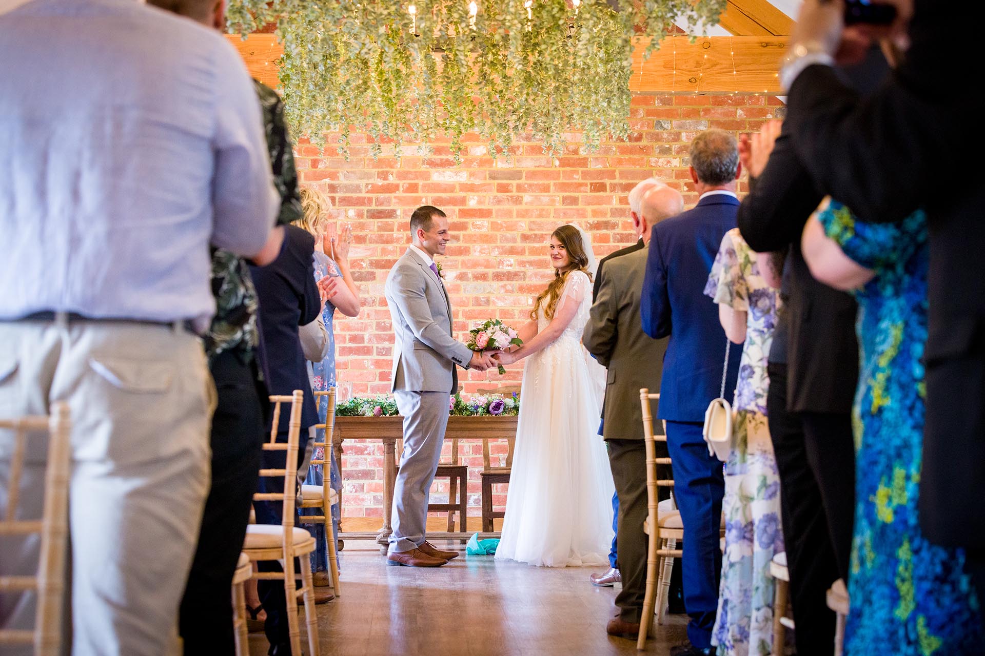 Photograph of the bride and groom in ceremony room at Apton Hall, Rochford, Essex