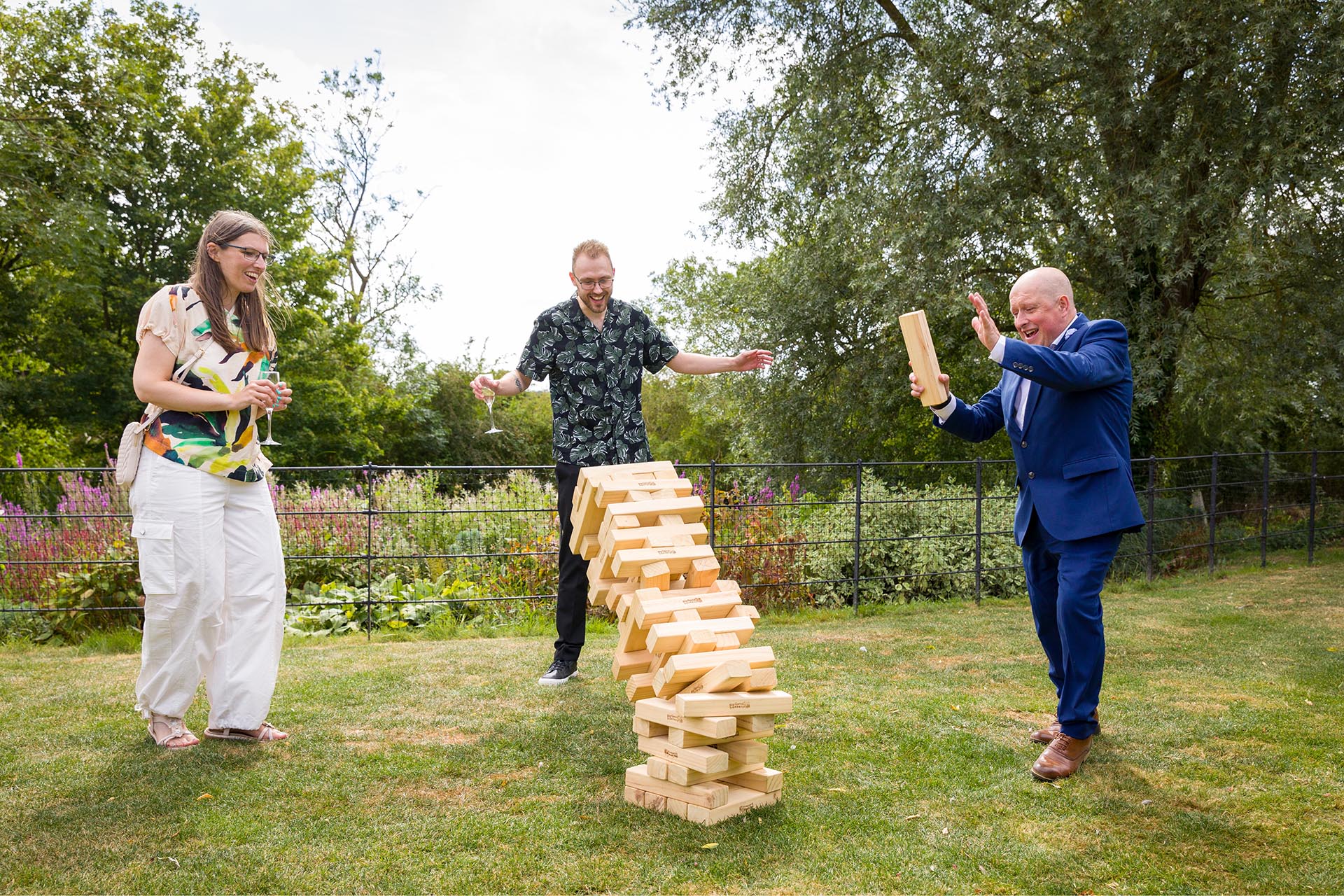 Candid photograph of wedding guests playing a garden game at Apton Hall, Rochford, Essex