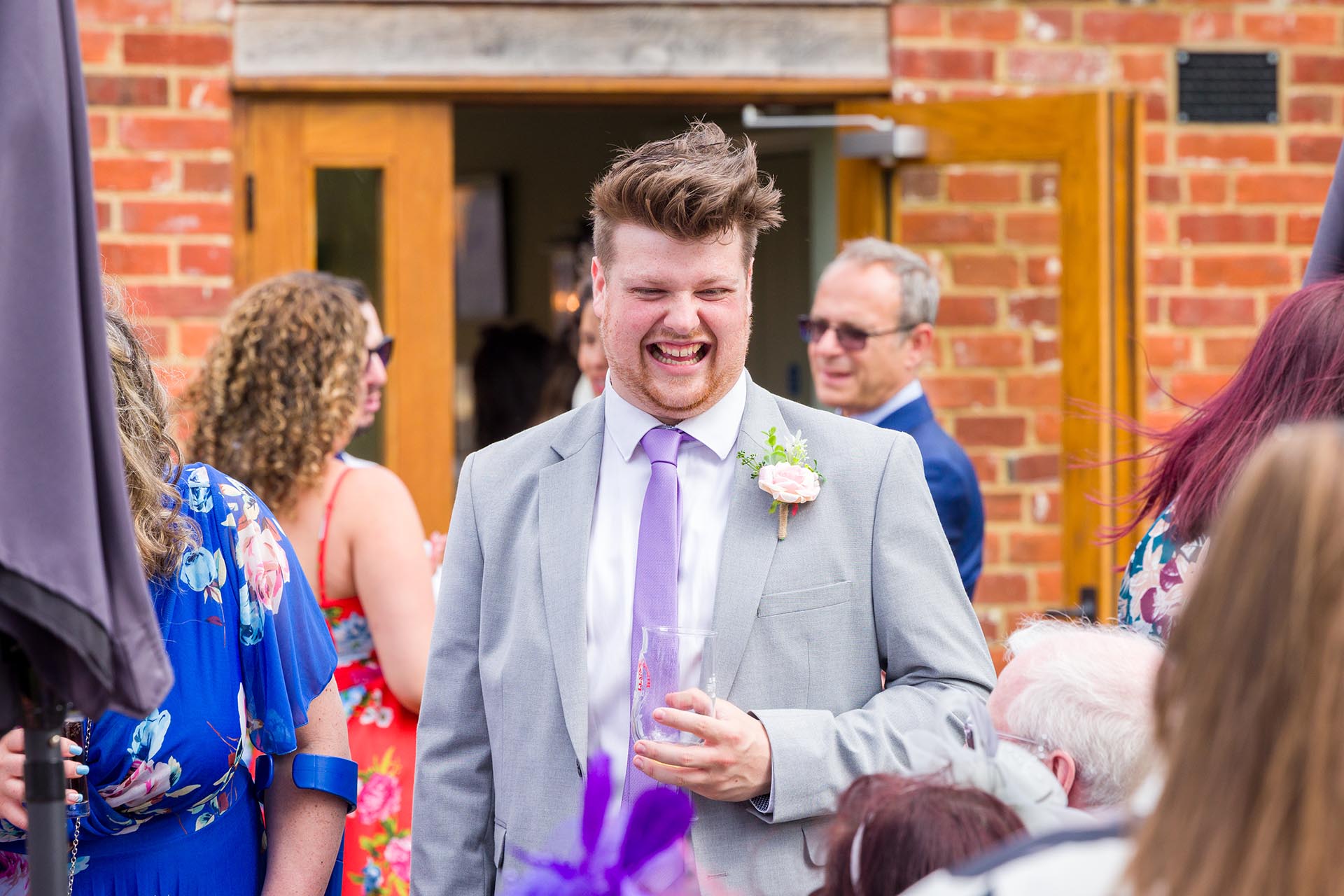 Candid photograph of a wedding guest at Apton Hall, Rochford, Essex