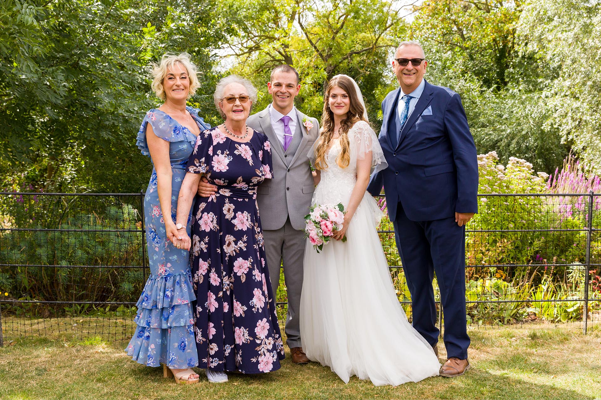 Group photograph of the bride and groom with family at Apton Hall, Rochford, Essex