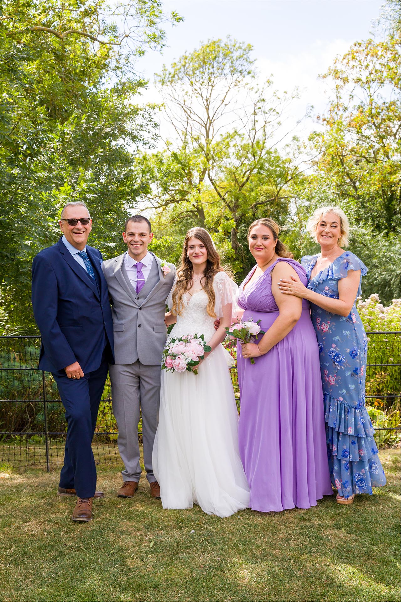 Group photograph of the bride and groom with family at Apton Hall, Rochford, Essex
