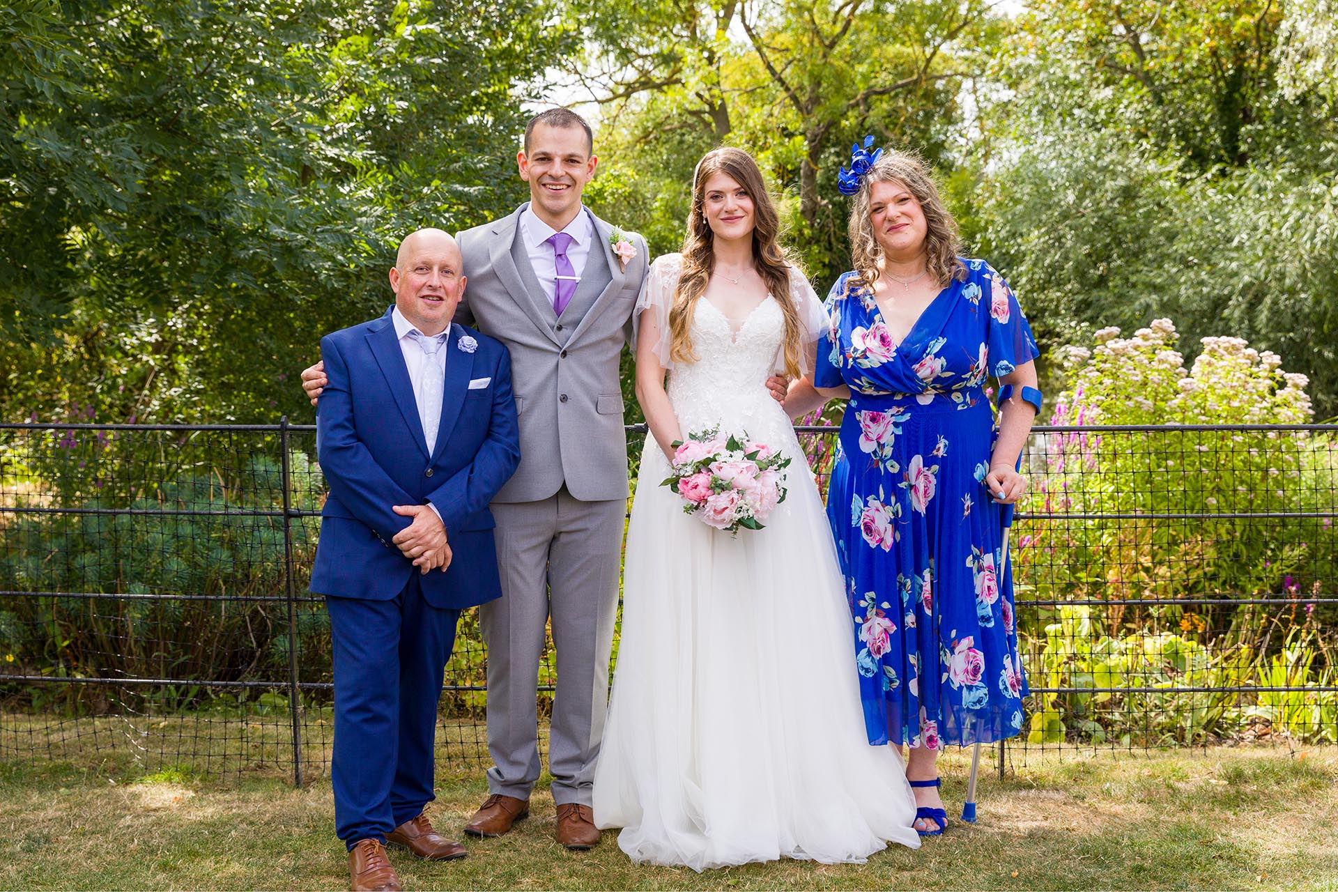 Group photograph of the bride and groom with family at Apton Hall, Rochford, Essex