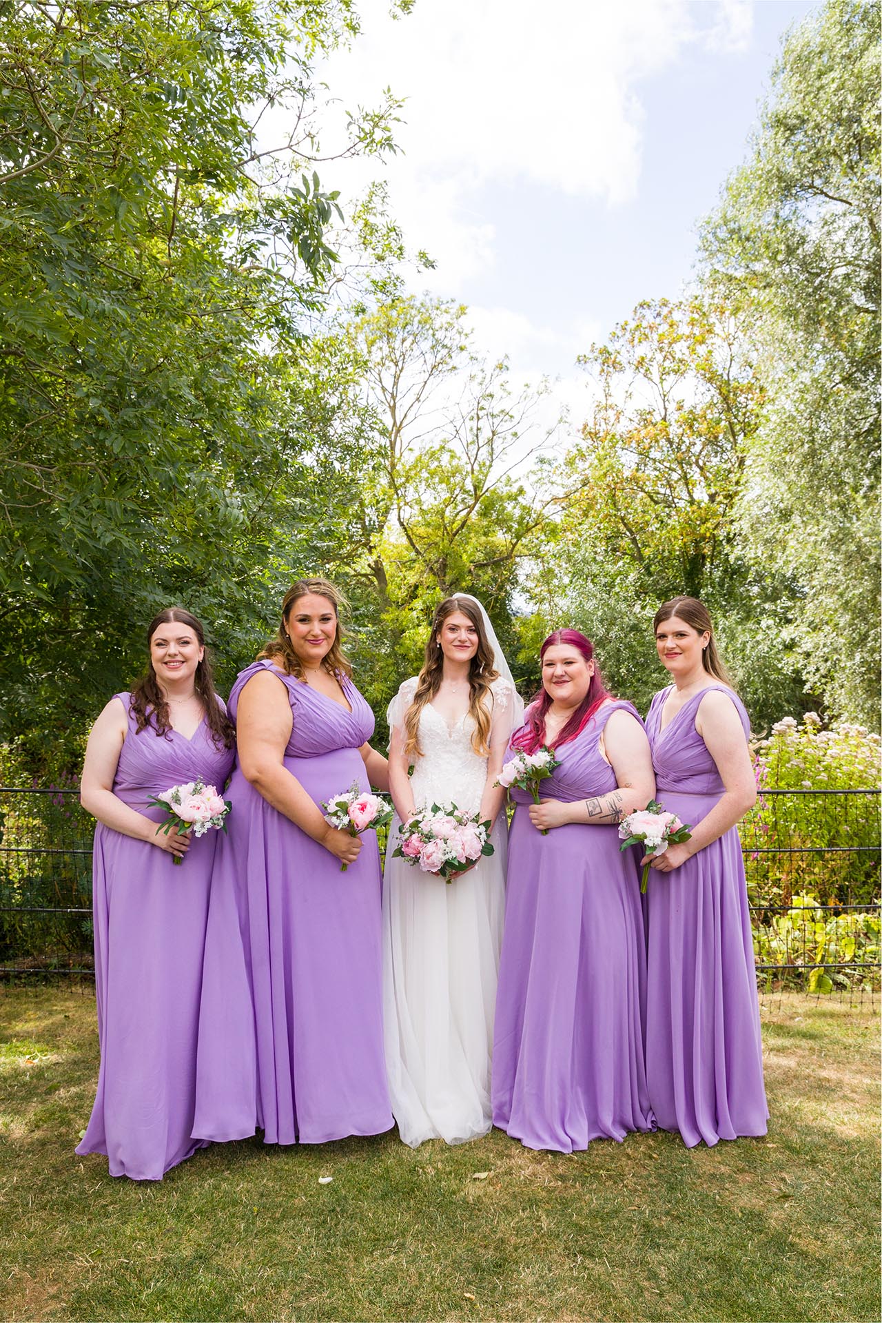 Group photograph of the bride with bridesmaids at Apton Hall, Rochford, Essex