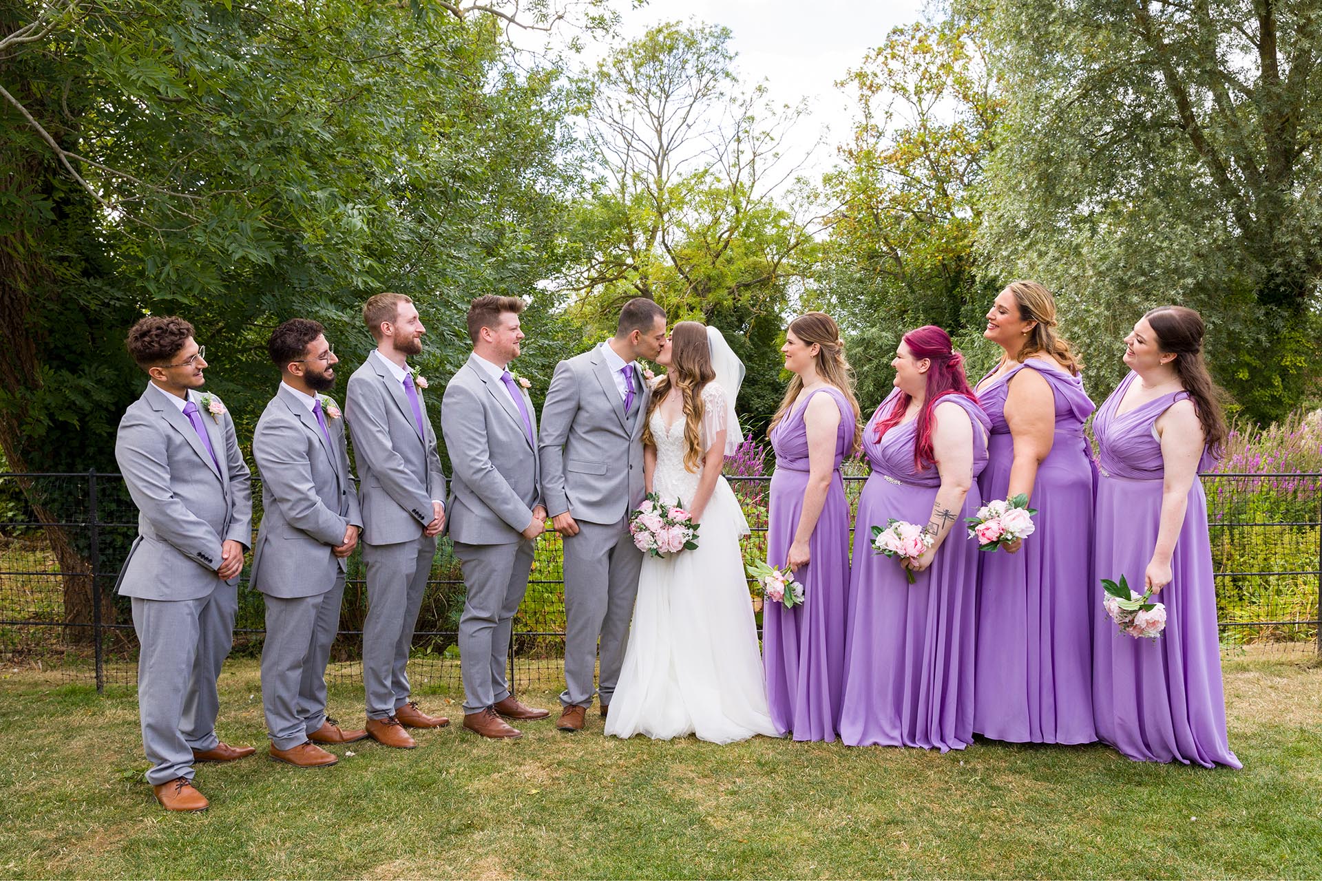 Group photograph of the bride and groom with bridesmaids and groomsmen at Apton Hall, Rochford, Essex