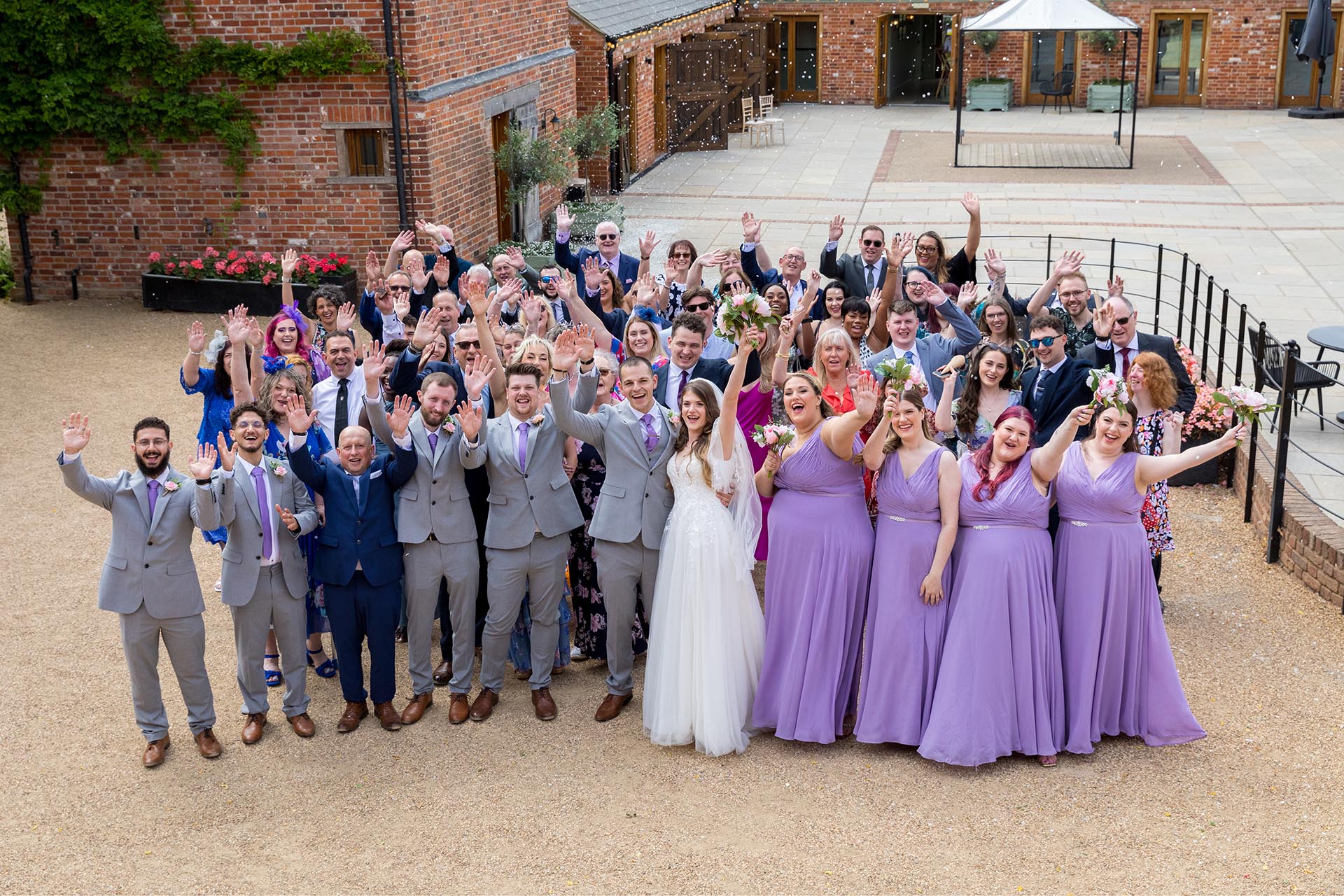 Large group photograph of the bride and groom with all of their guests at Apton Hall, Rochford, Essex
