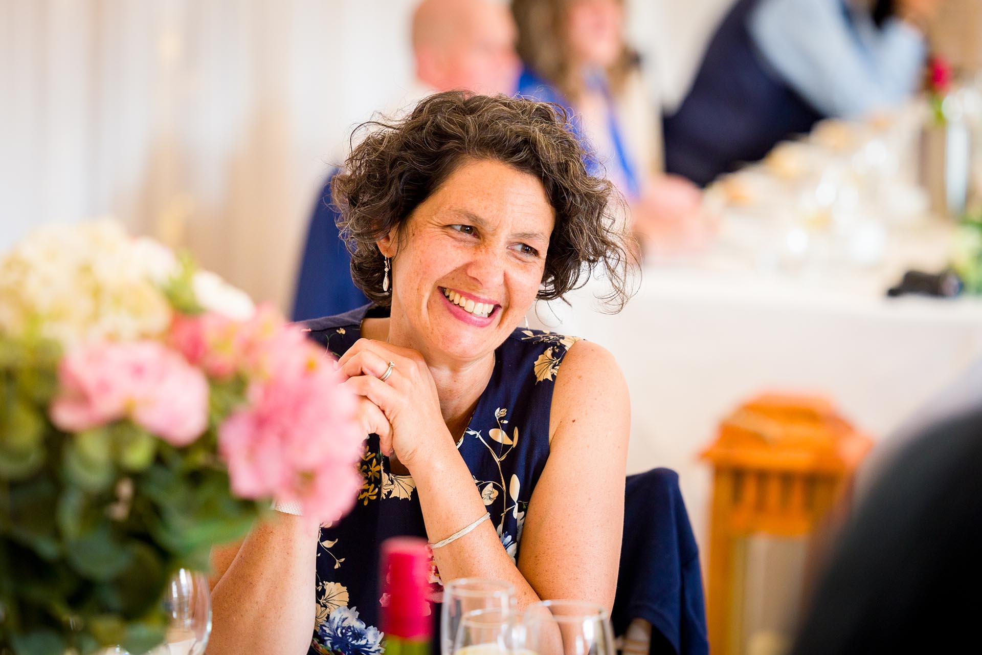 Photograph of wedding guest laughing at Apton Hall, Rochford, Essex