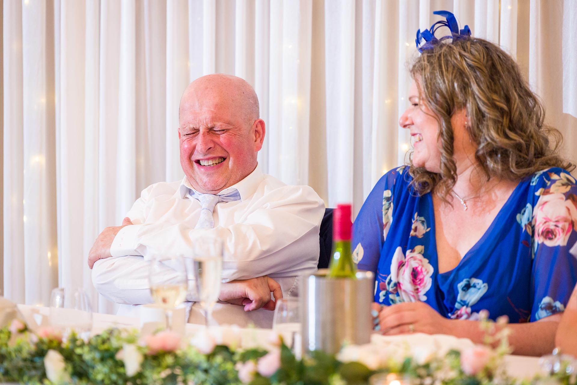 Photograph of wedding guests laughing at Apton Hall, Rochford, Essex
