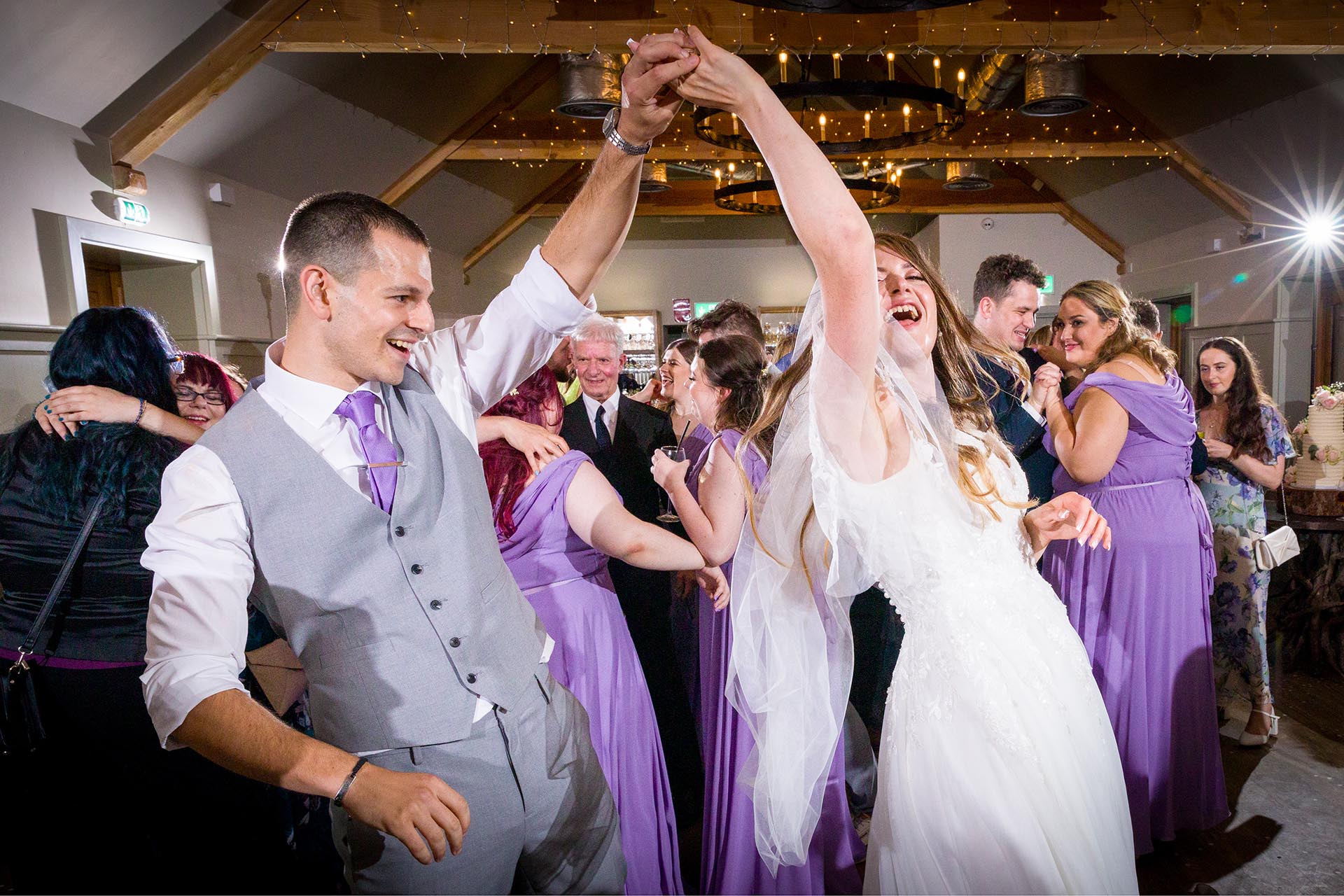 Colourful photograph of bride and groom dancing at Apton Hall, Rochford, Essex
