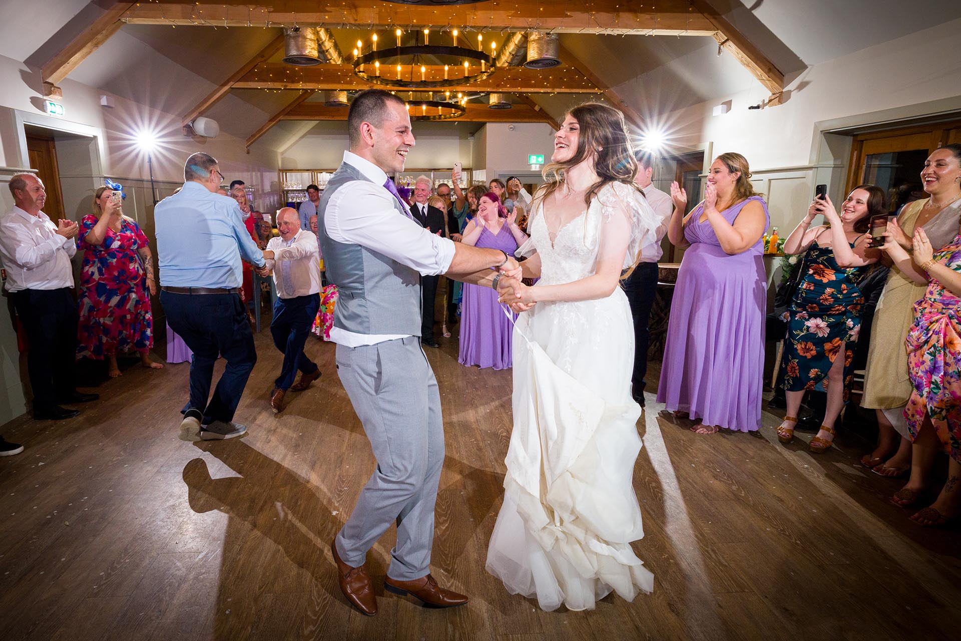 Colourful photograph of bride and groom dancing at Apton Hall, Rochford, Essex