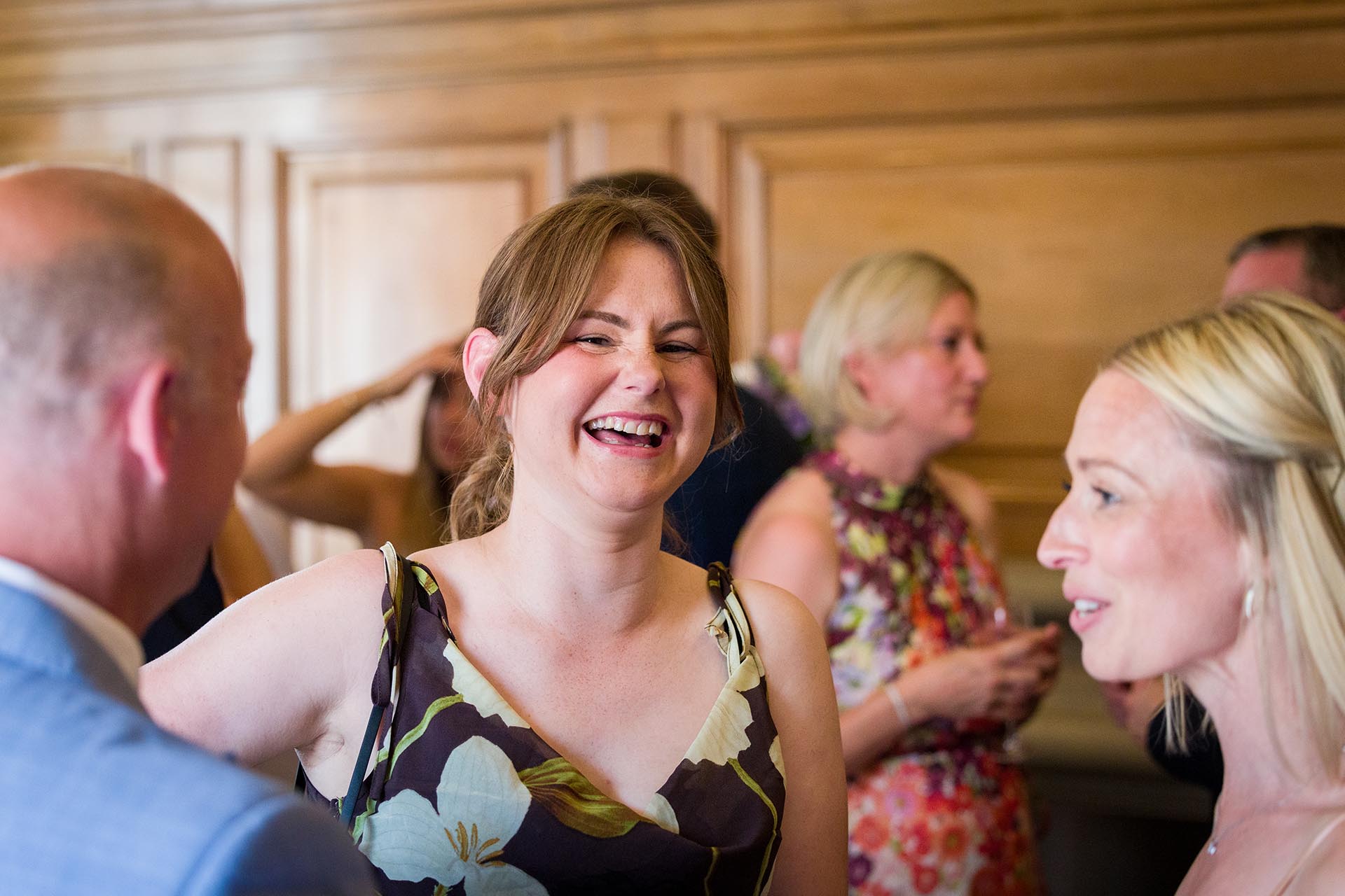 Photograph of a laughing wedding guest