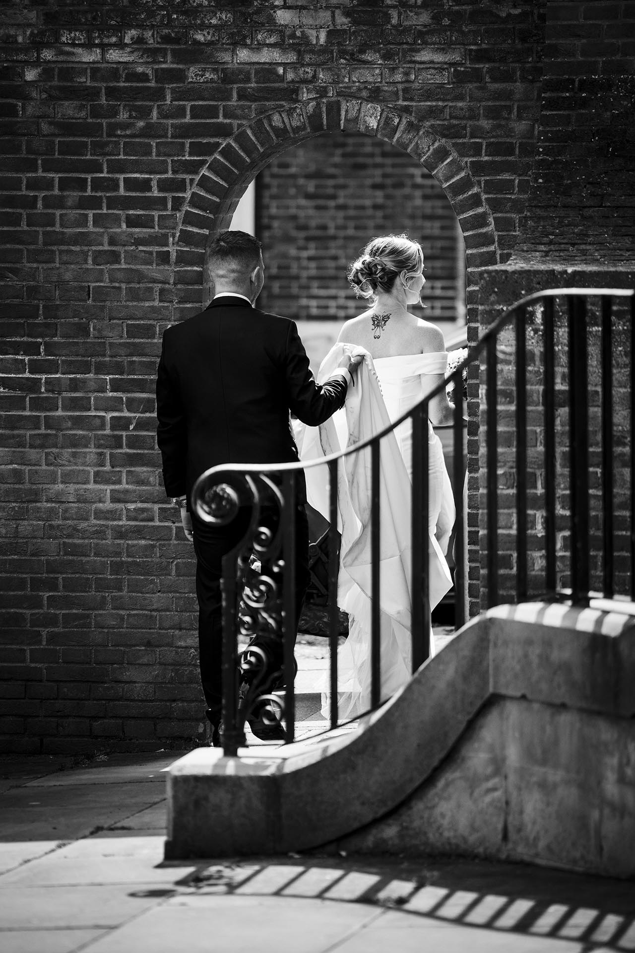 Black and white photograph of the bride and groomleaving Braintree Town Hall, Braintree, Essex