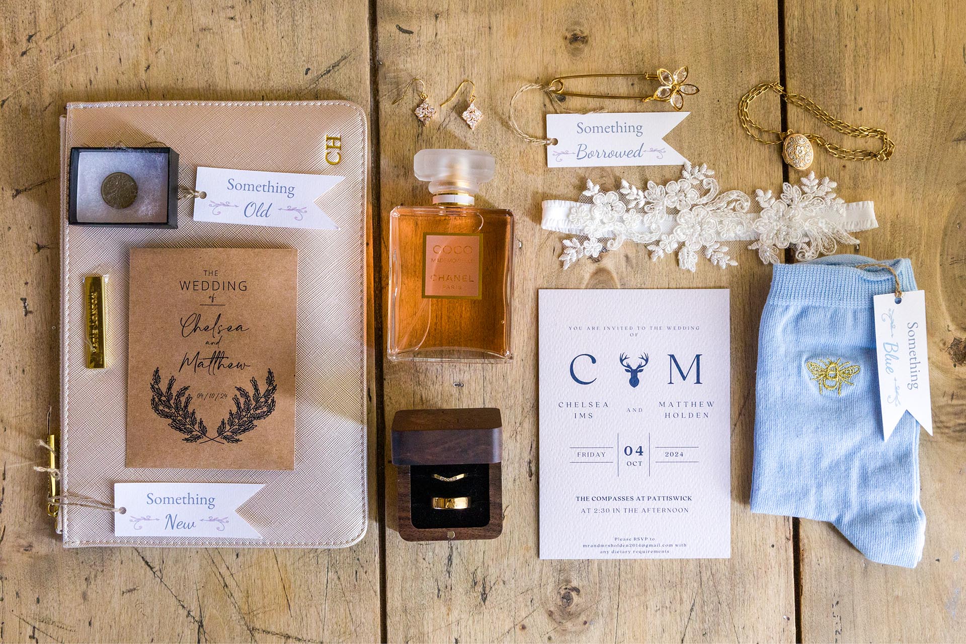Photograph of bride's accessories on her wedding day including wedding rings, perfume, something old, something new, something borrowed and something blue