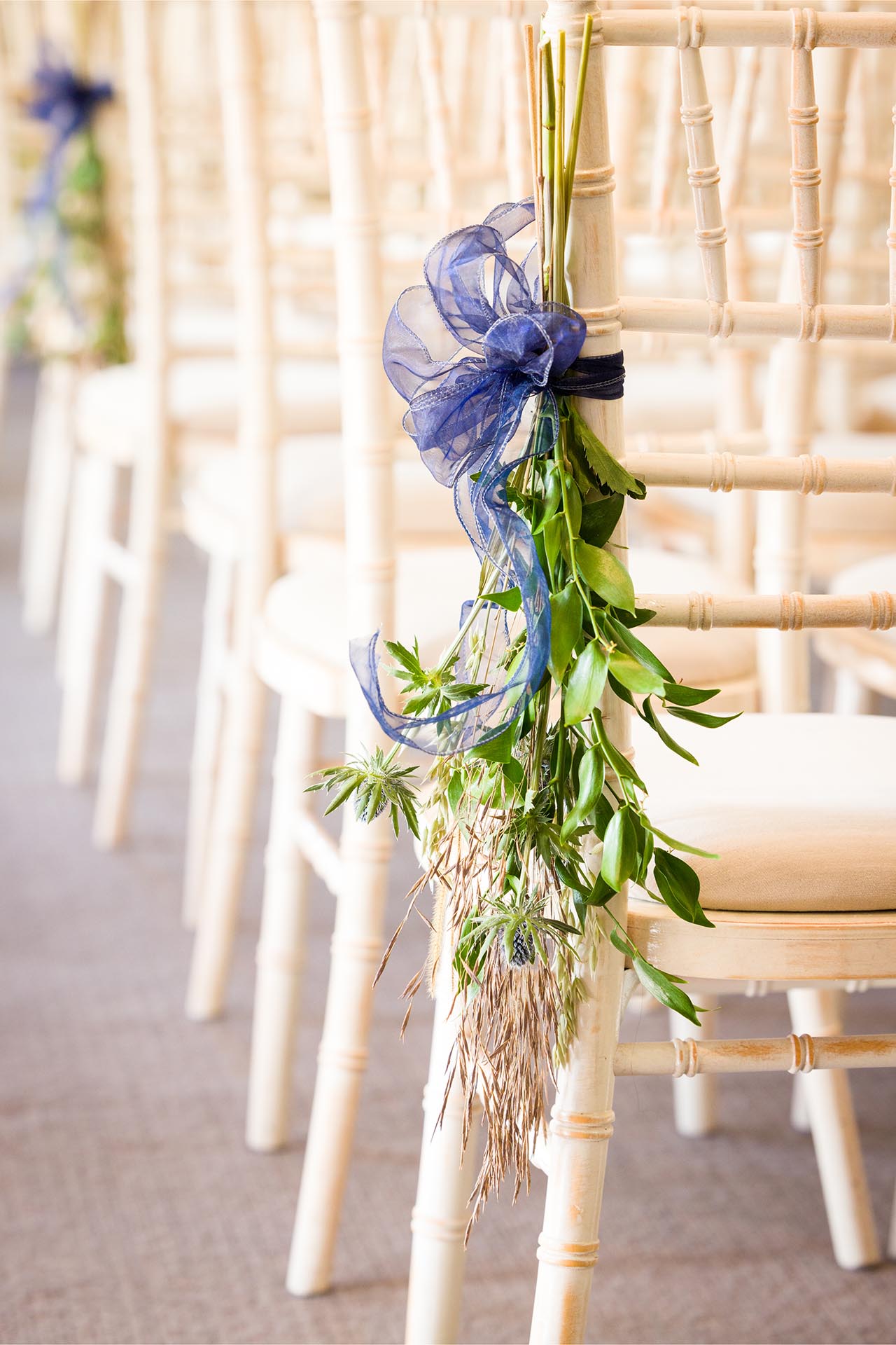 Detail photograph of wedding flowers on a chair in the ceremony room