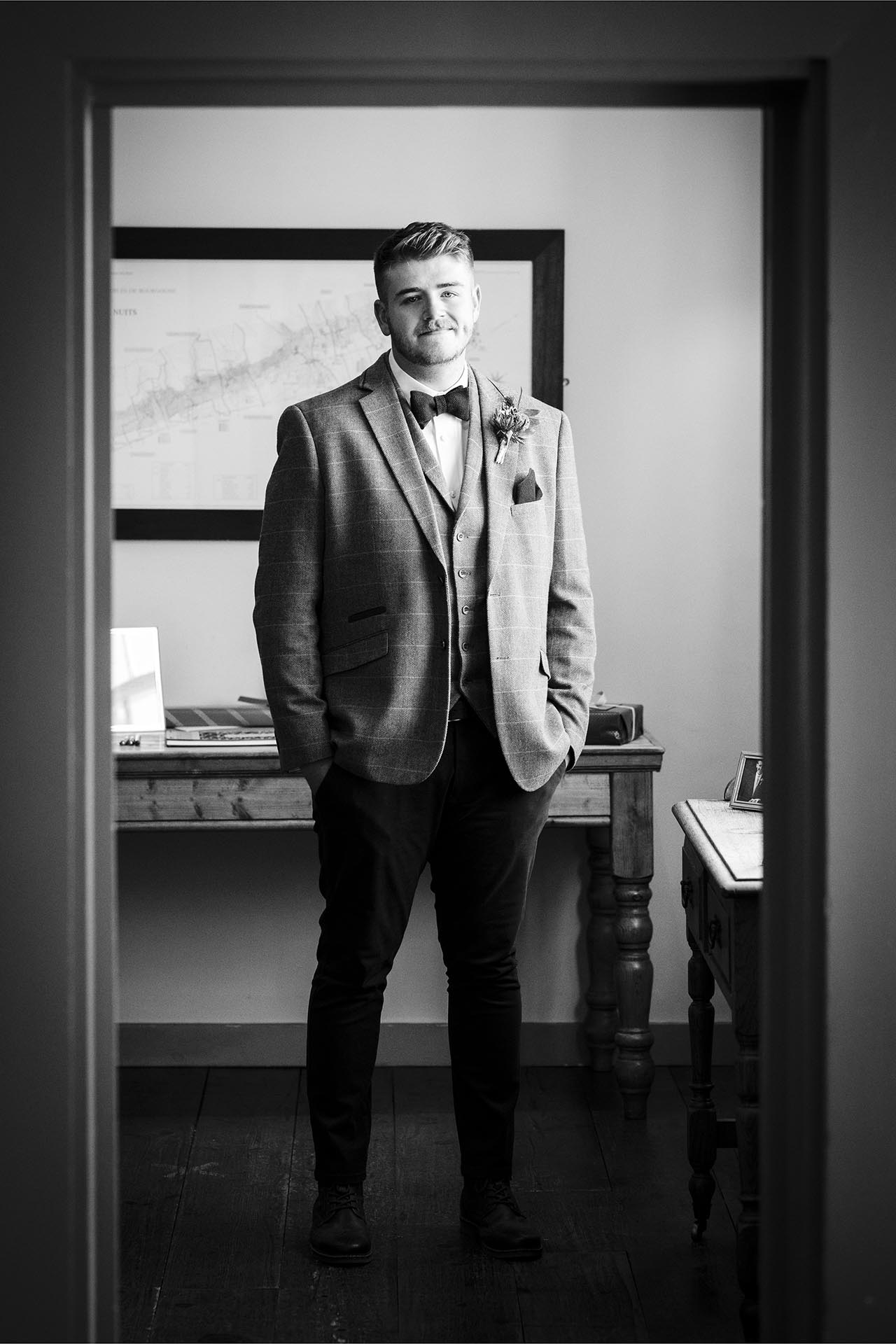 Black and white portrait photograph of groom at The Compasses at Pattiswick, Essex