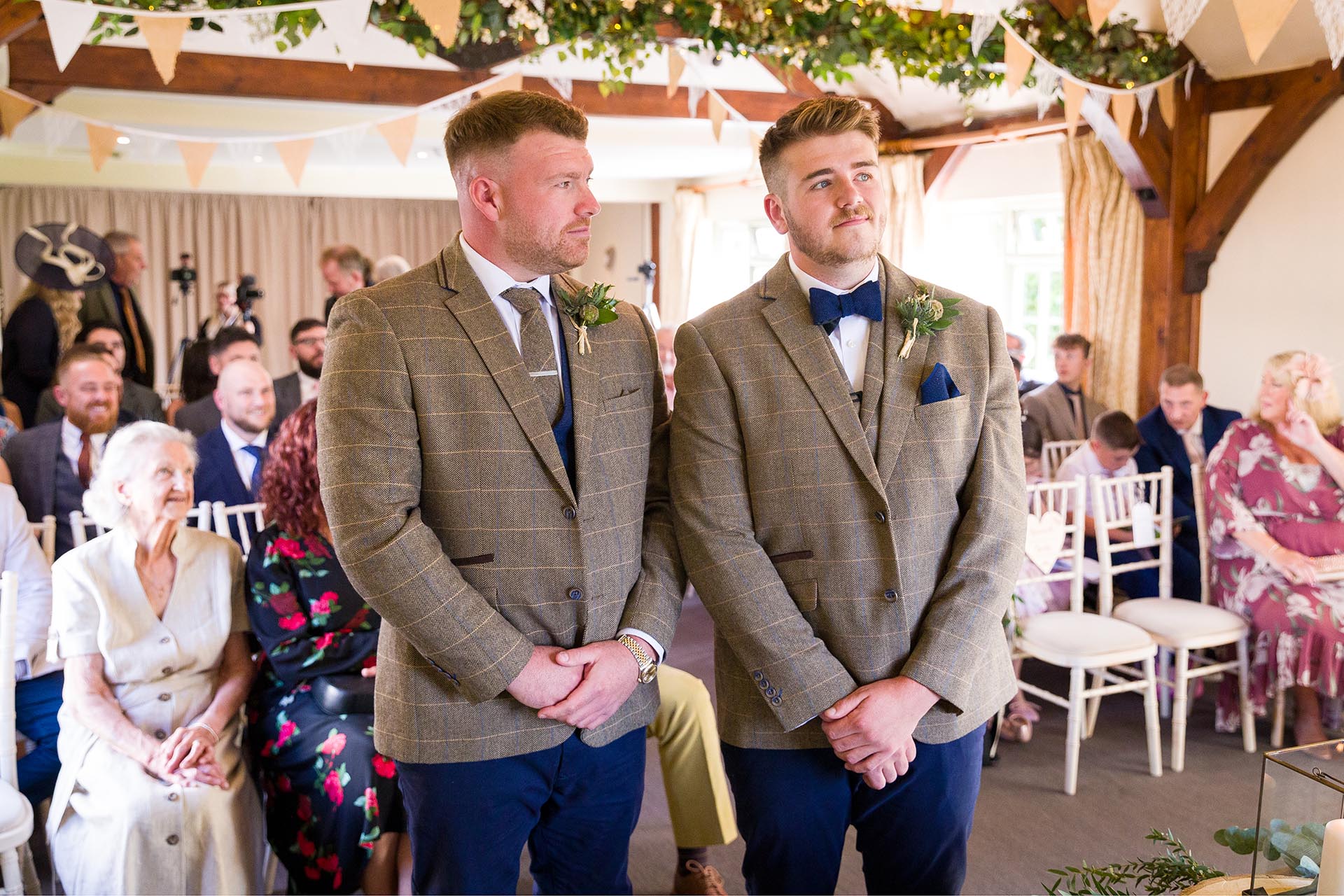 Photograph of groom and best-man waiting in the ceremony room at The Compasses at Pattiswick, Essex
