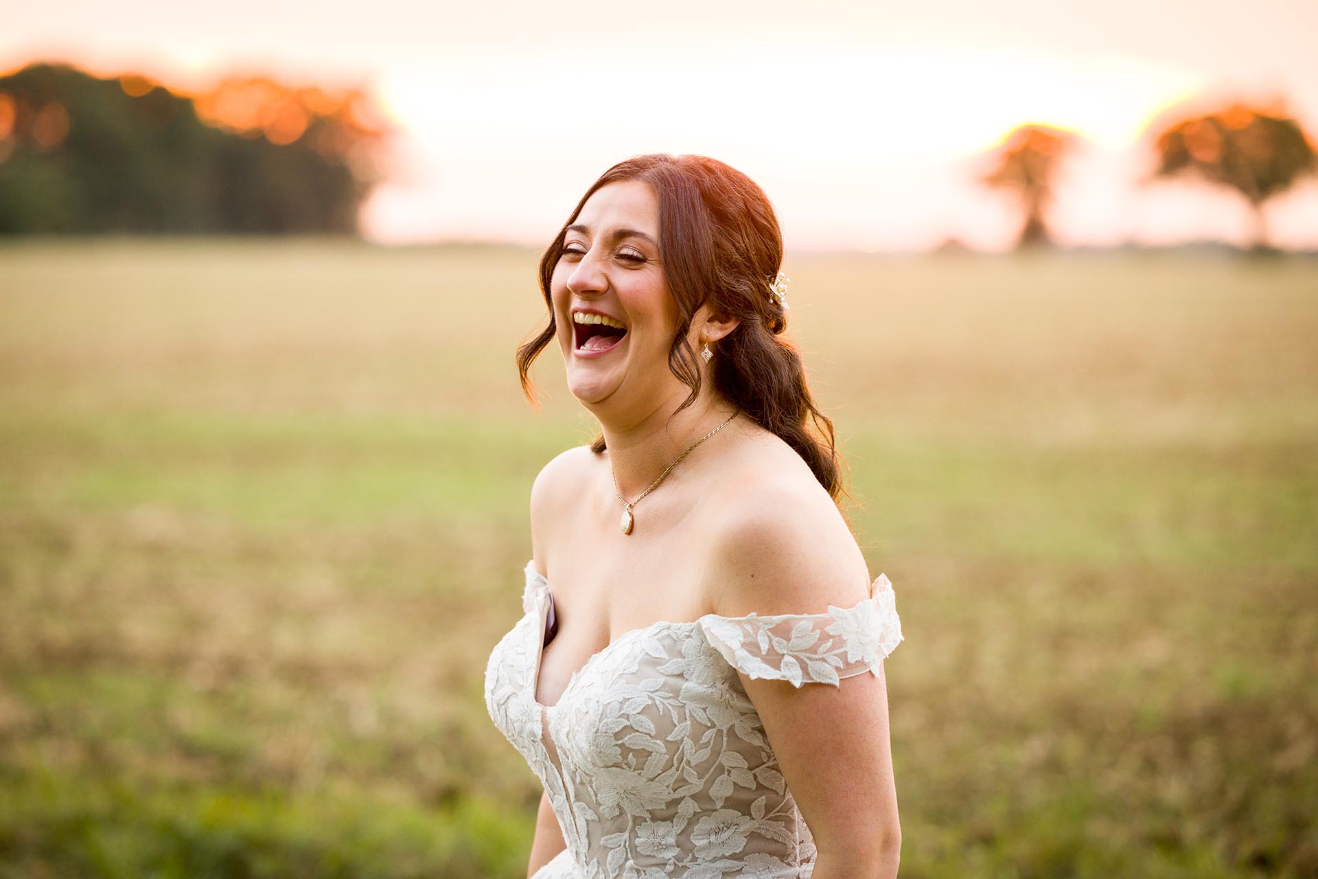 Photograph of bride laughing at The Compasses at Pattiswick