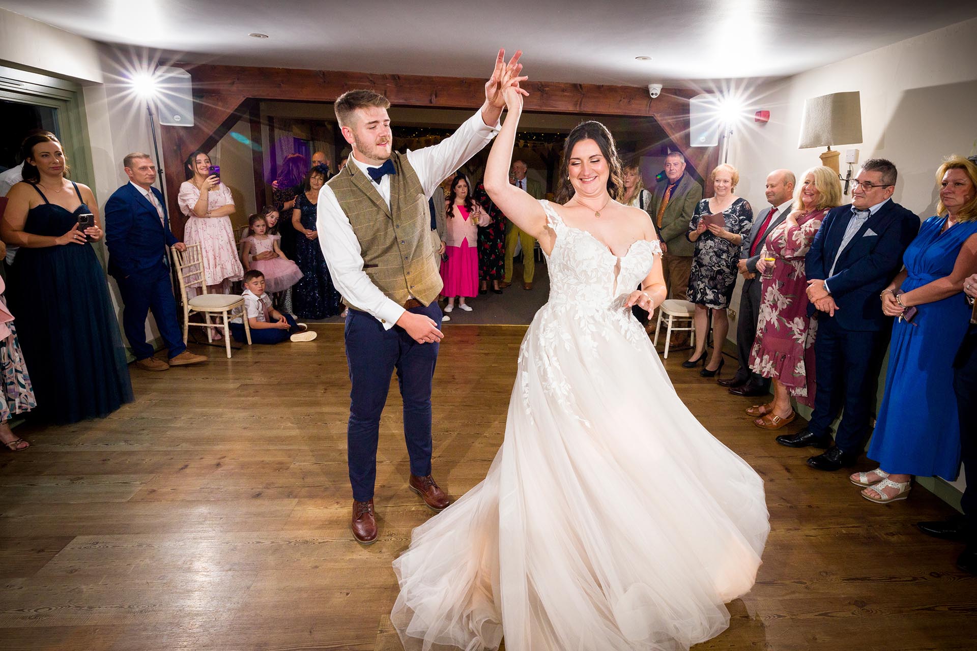 Photograph of bride and groom's first dance infront of guests at The Compasses at Pattiswick