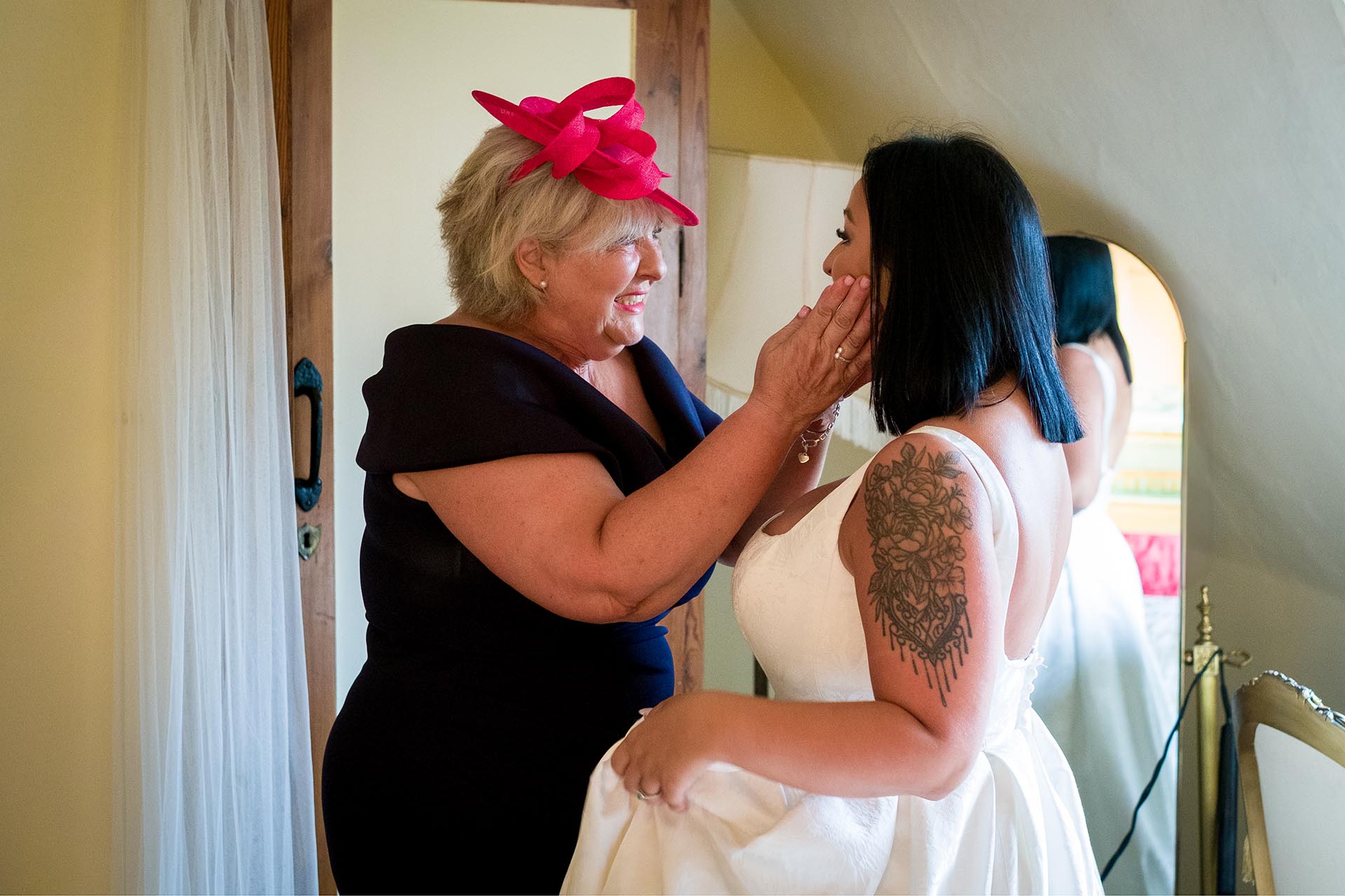 Photograph of bride and her mother during wedding preparations