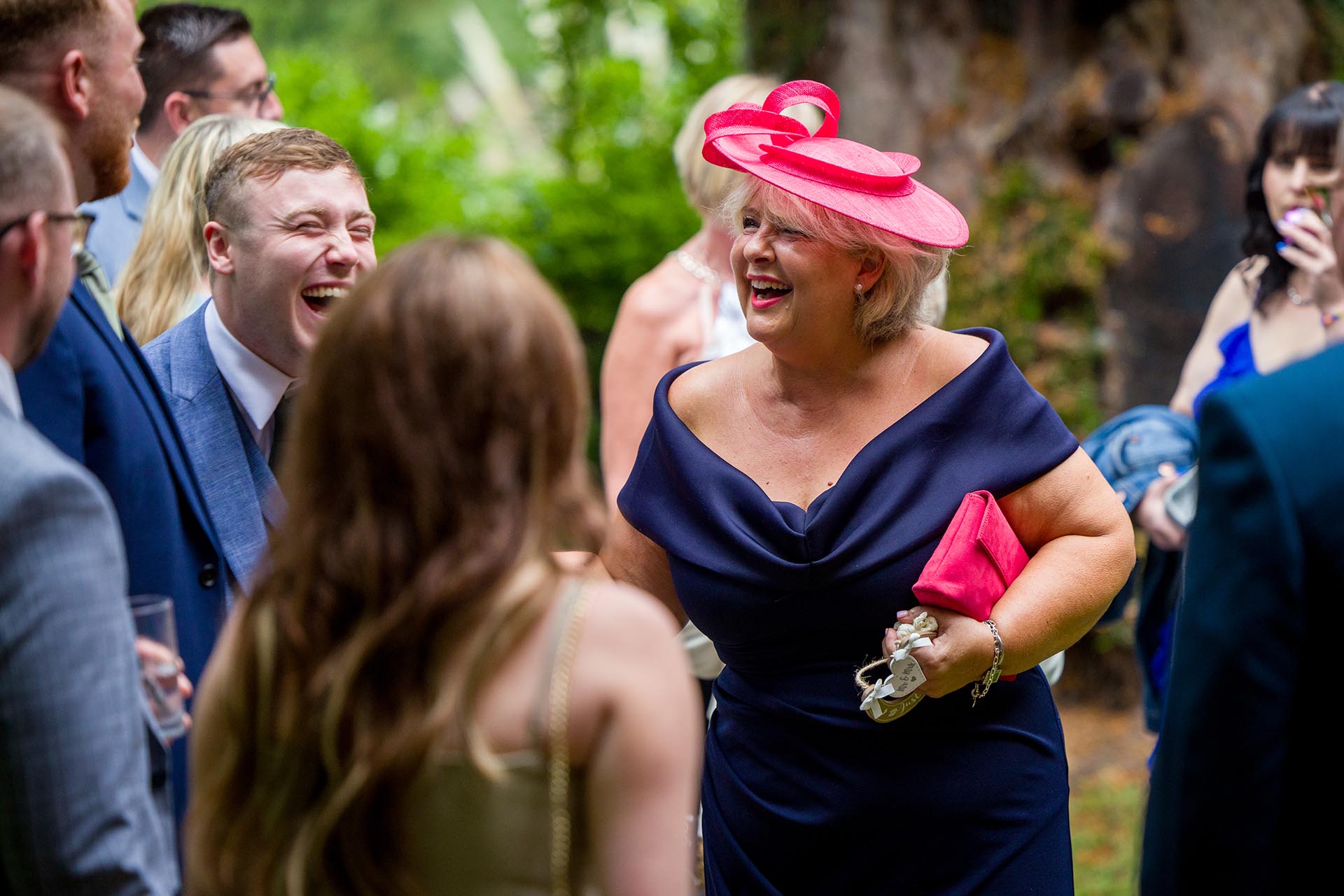 Photograph of wedding guests laughing