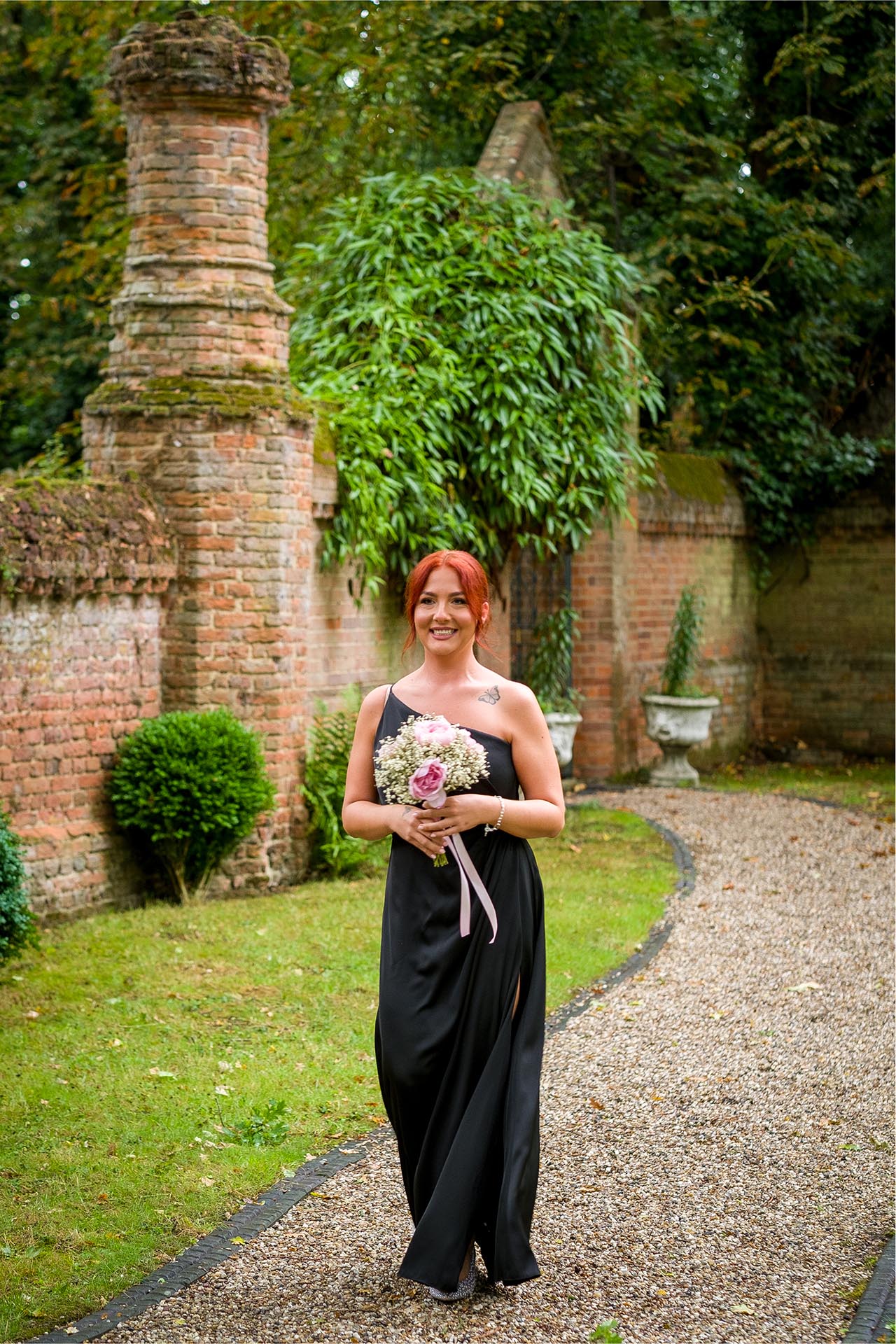 Photograph of bridesmaid arriving for outdoor ceremony