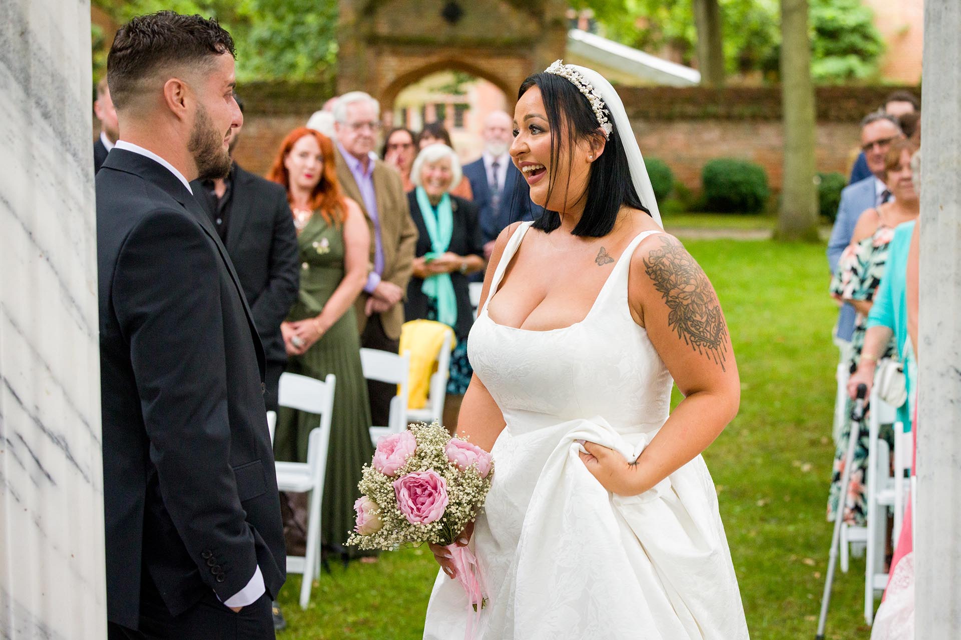 Photograph of bride laughing during outdoor wedding ceremony