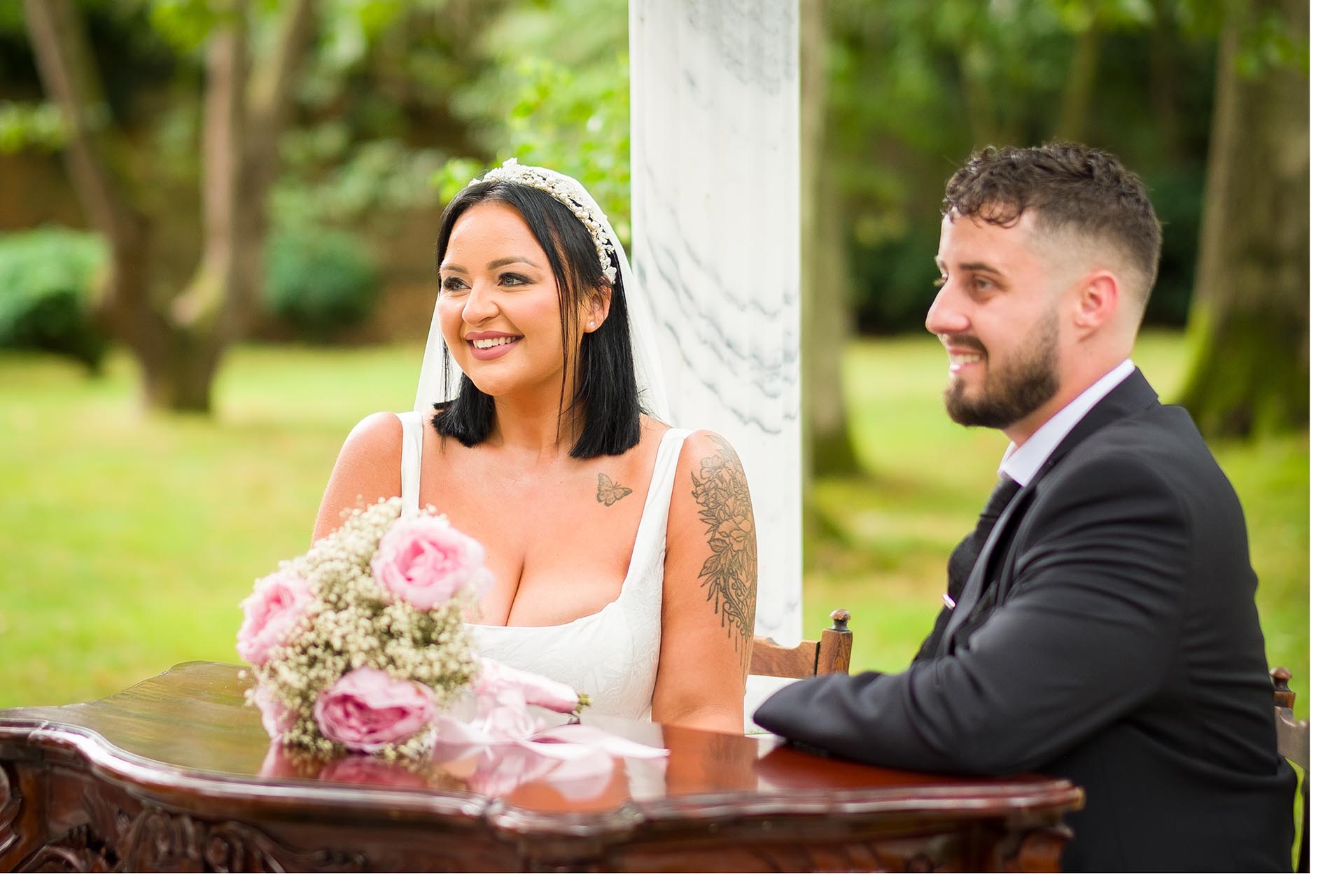 Photograph of bride and groom seated at ceremony table at Creeksea Place Manor, Burnham-on-Crouch, Essex