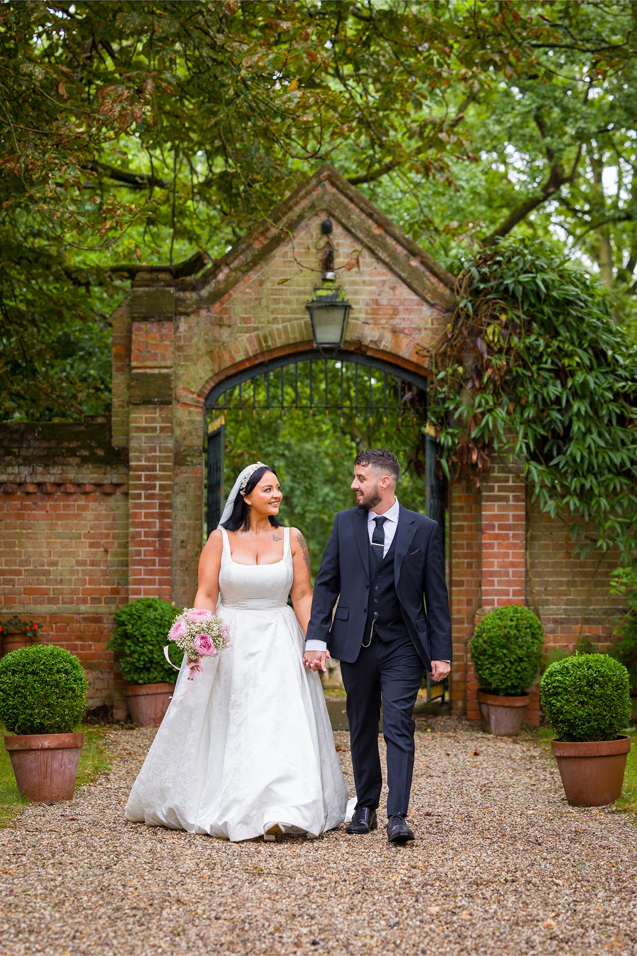 Photograph of bride and groom walking