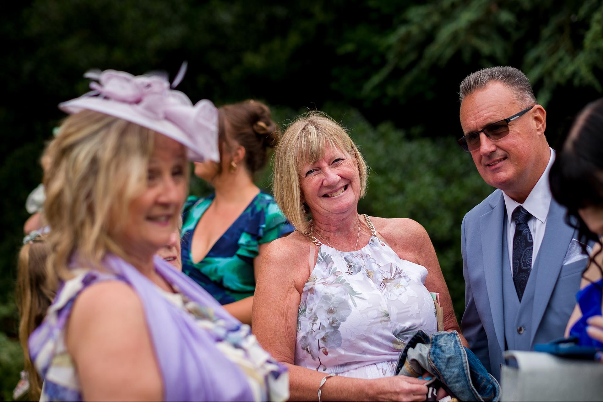Photograph of wedding guests laughing